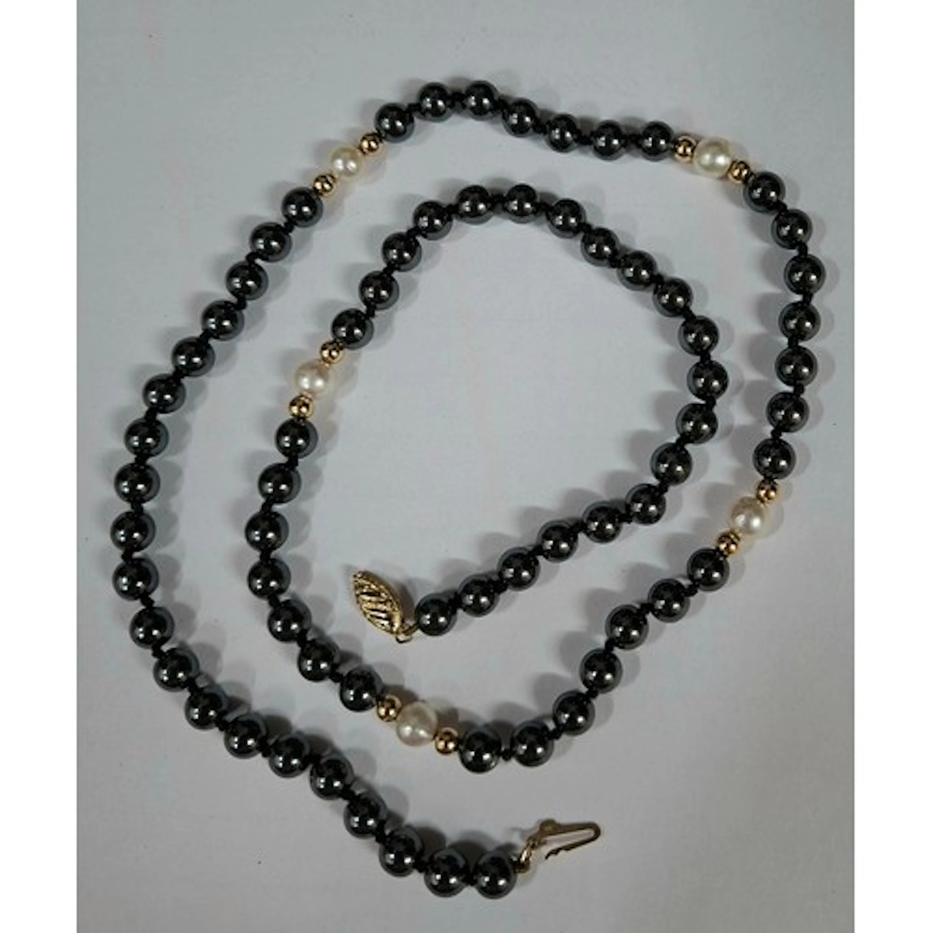 A Hematite, pearl and yellow metal bead necklace having a 9c...