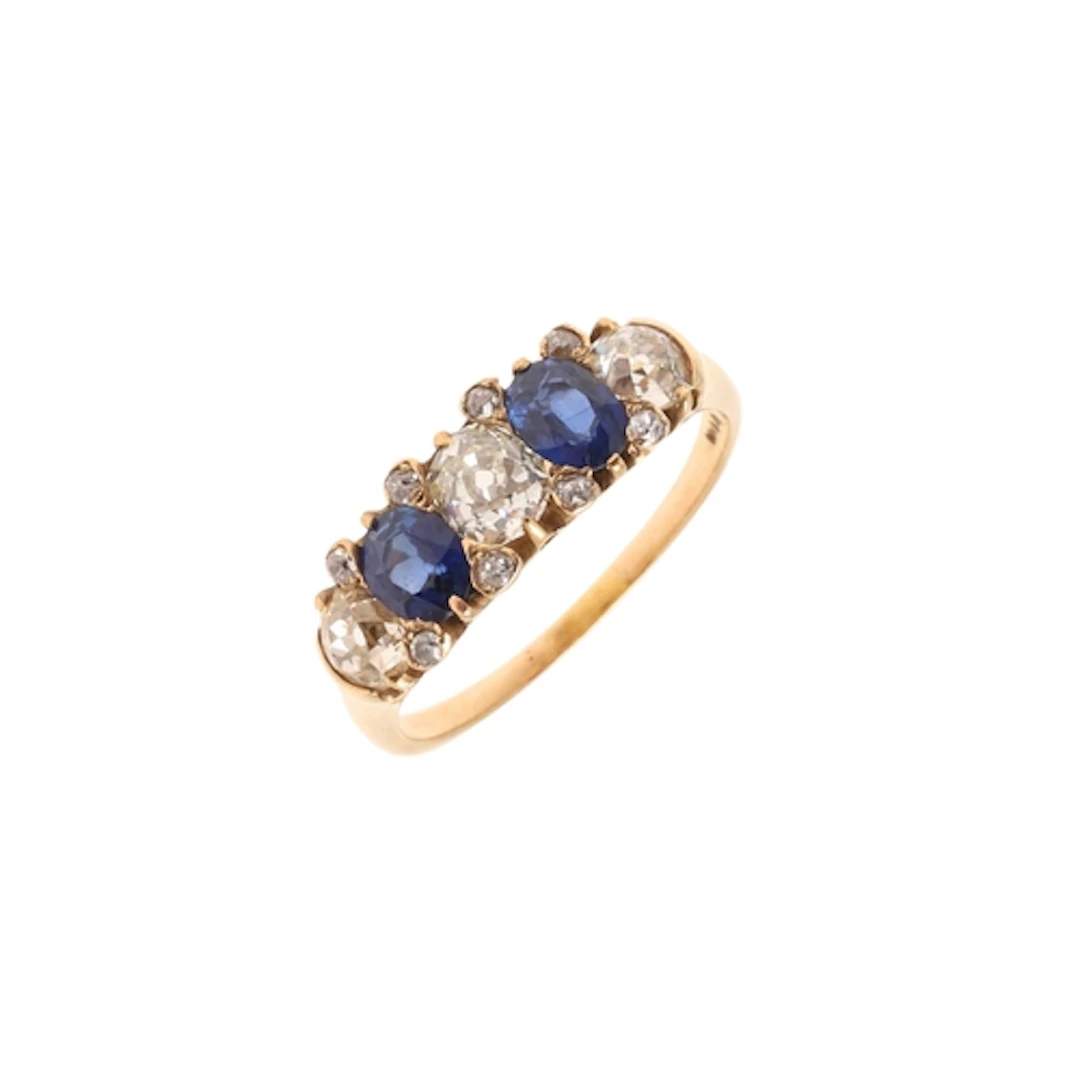 A SAPPHIRE AND DIAMOND FIVE STONE RING. the two oval-shaped ...