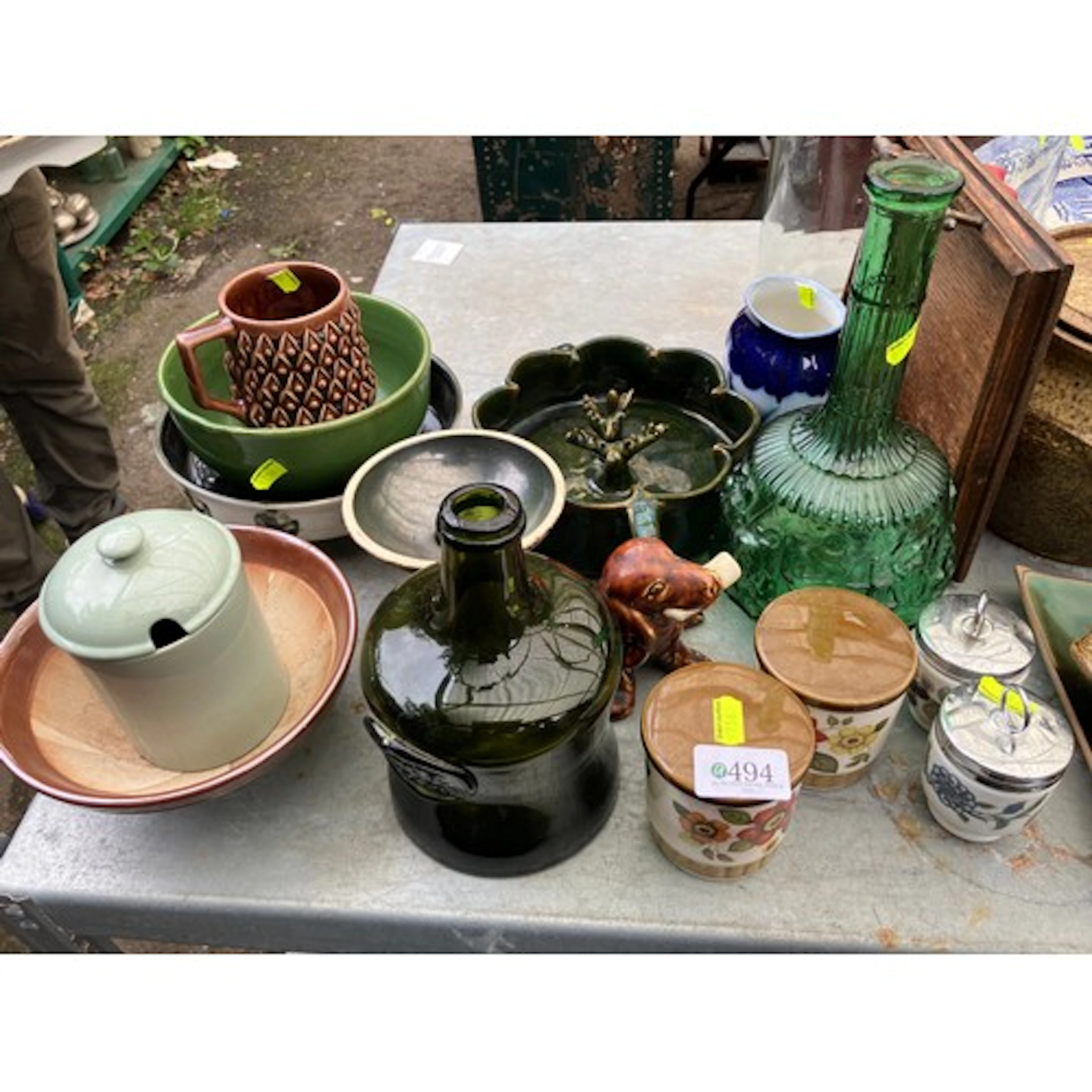 A group of decorative tablewares, including a green pressed-...