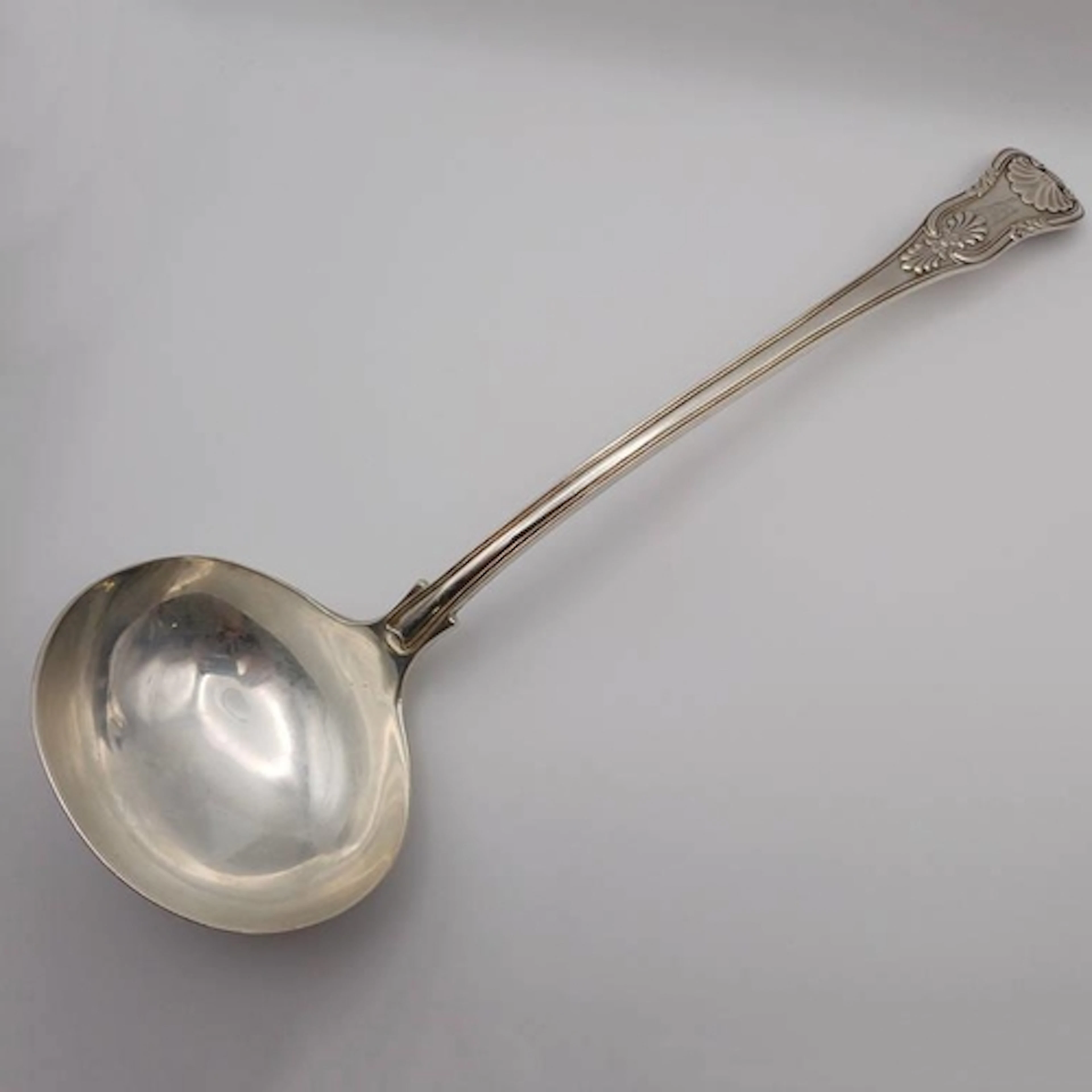 A GEORGE IV SILVER KINGS PATTERN SOUP LADLE BY WILLIAM CHAWN...