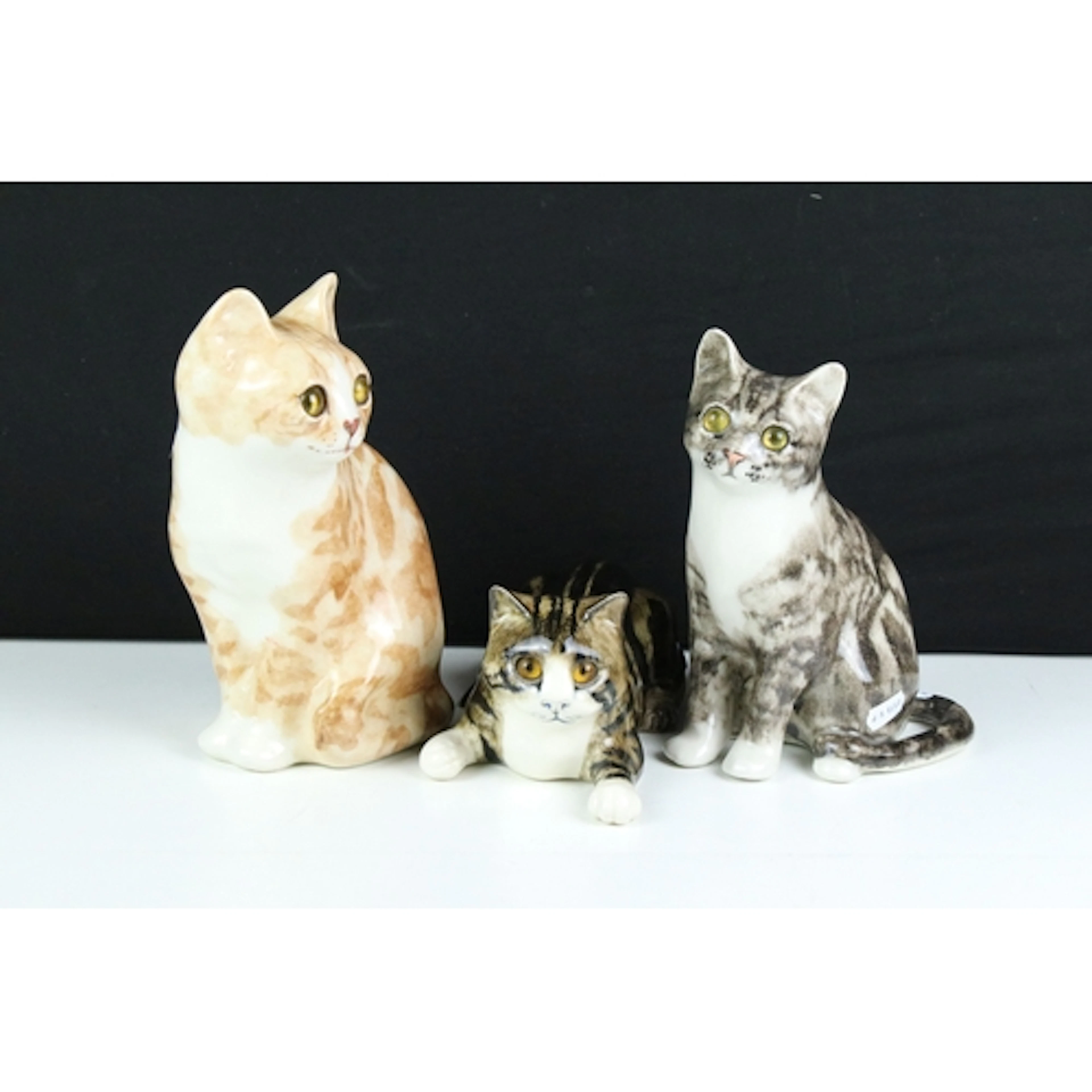 Two Winstanley cat figurines with yellow glass eyes to inclu...