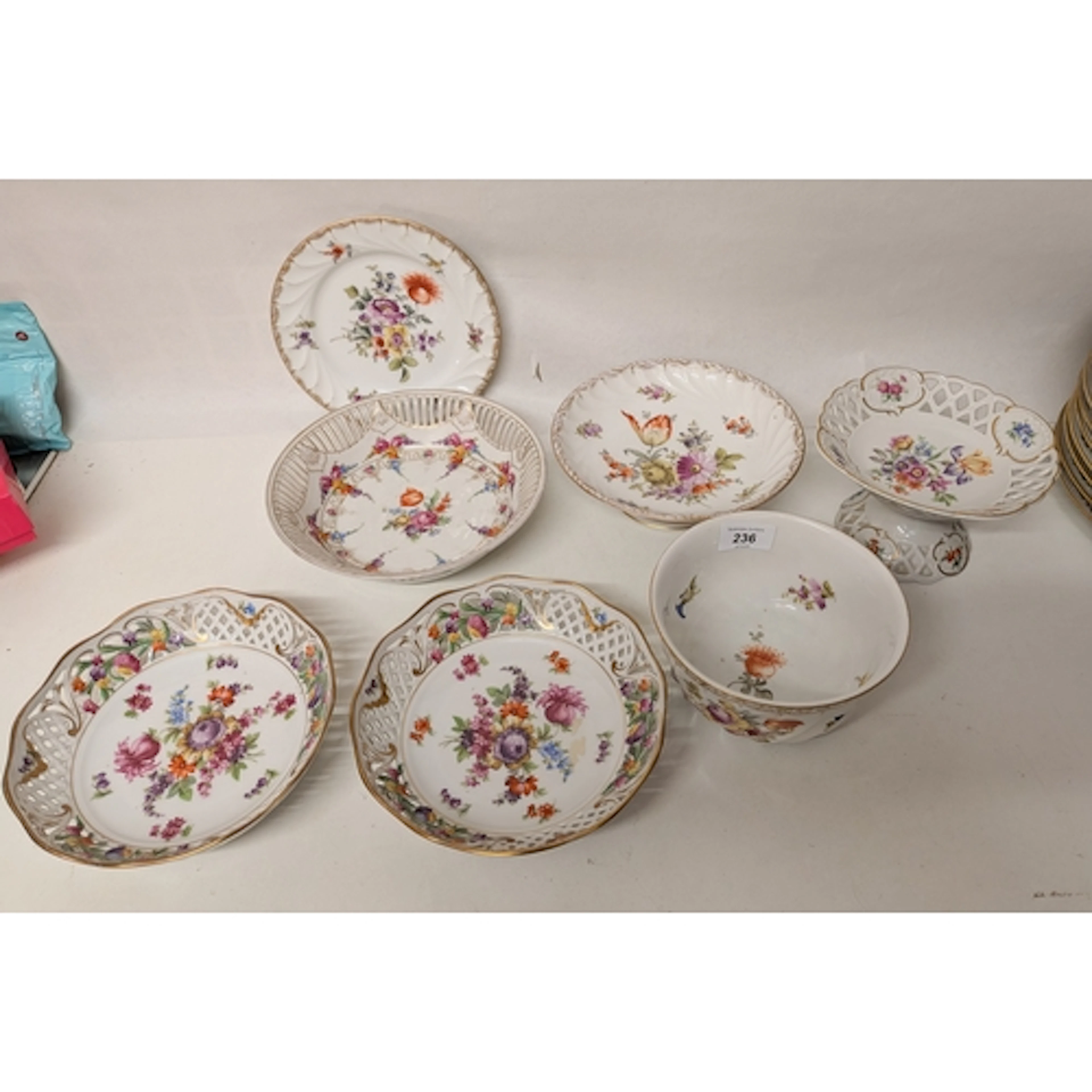A collection of Dresden ribbon plates, baskets and a slop bo...