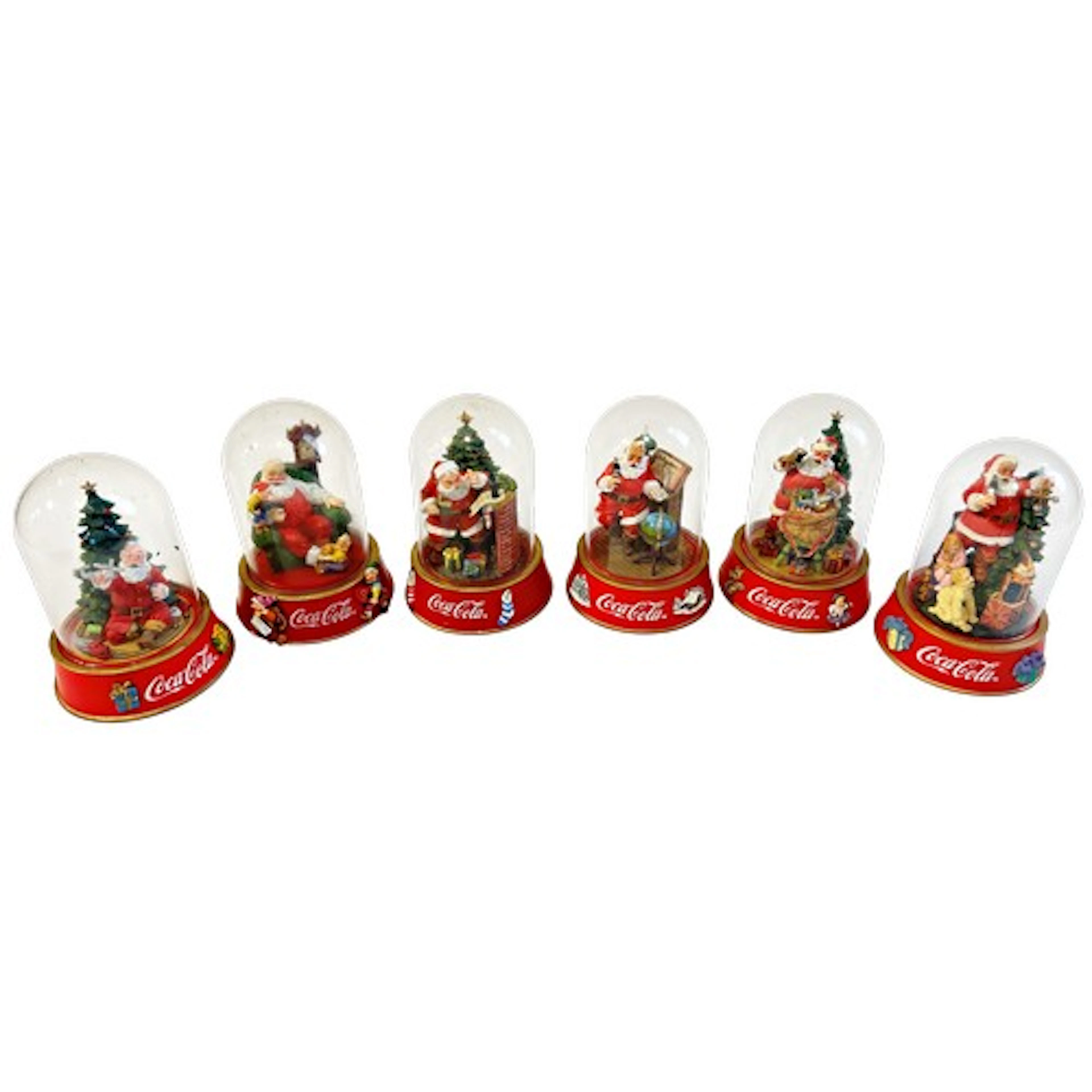 A collection of Coca Cola collectors domes depicting santa i...