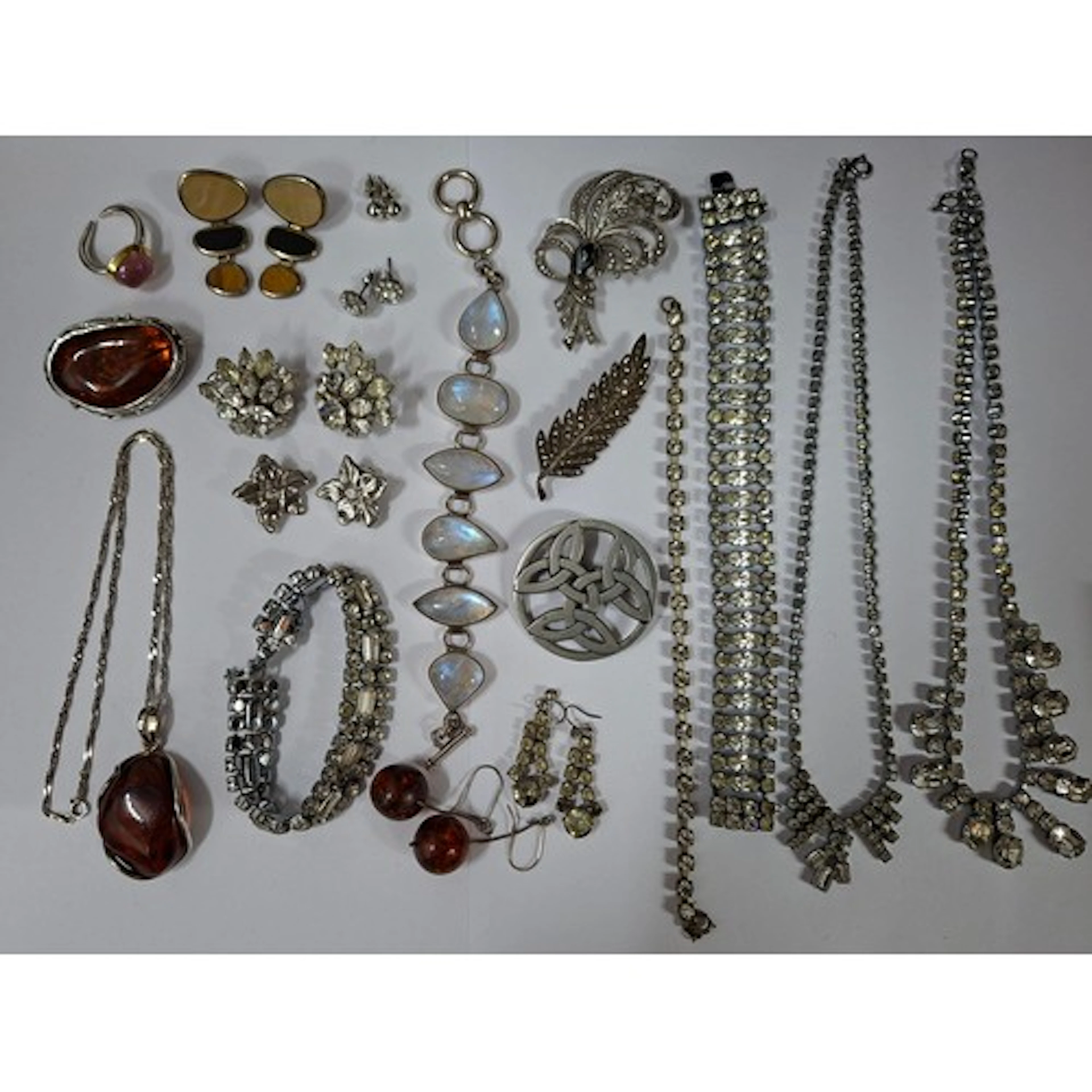 A quantity of silver, silver tone and white paste stone jewe...