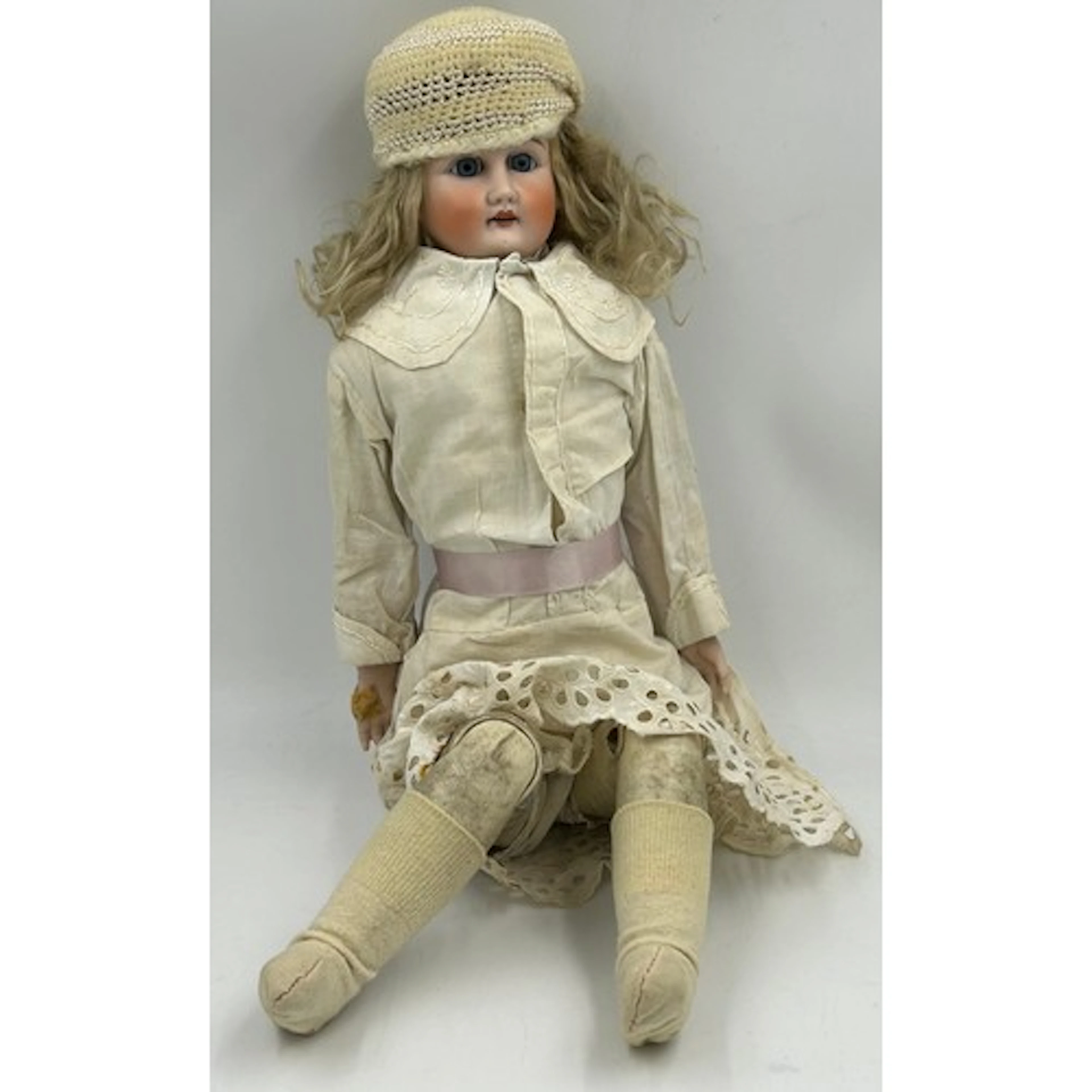 A bisque headed doll with leather body and leather jointed l...