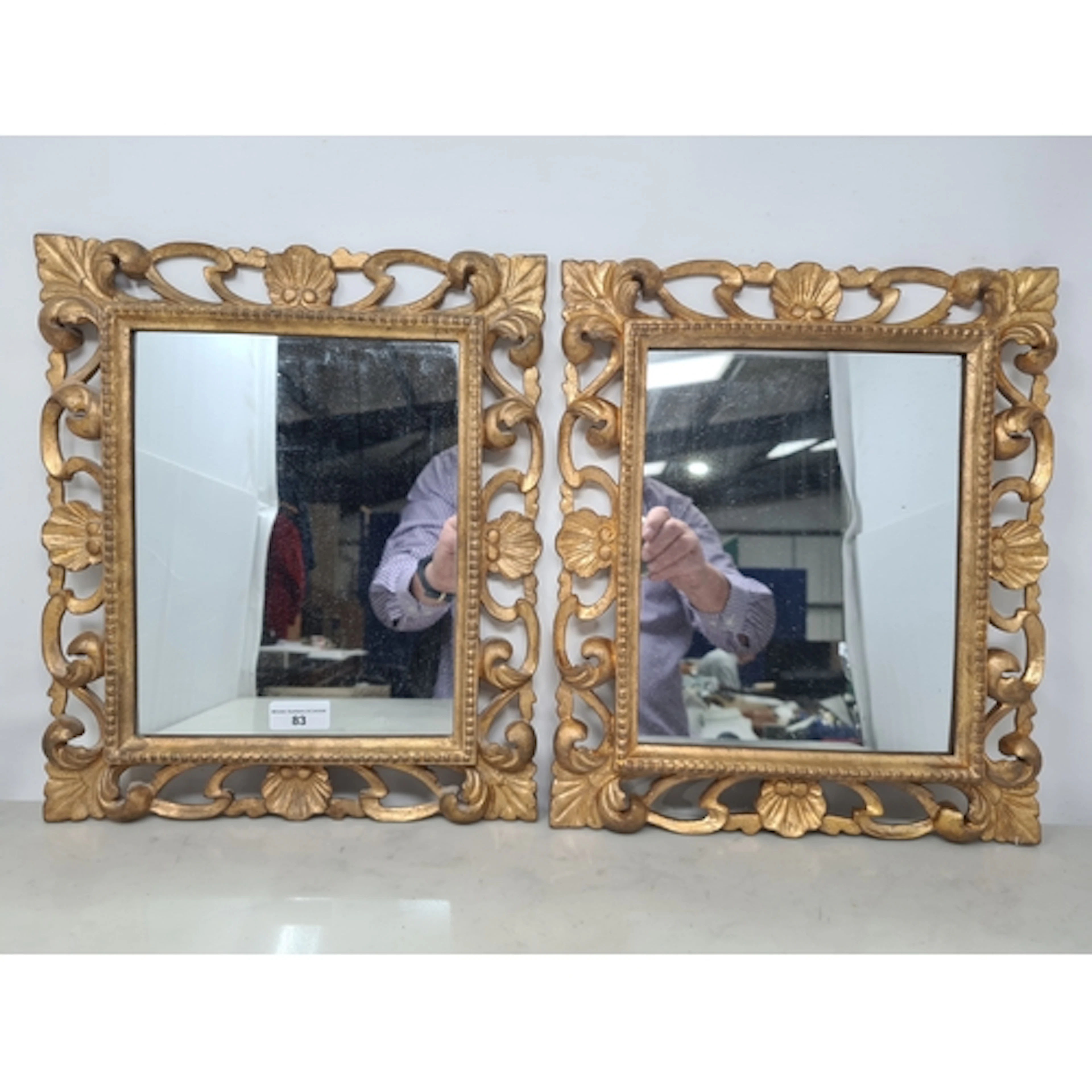 A pair of small gilt framed Mirrors with pierced and scallop...
