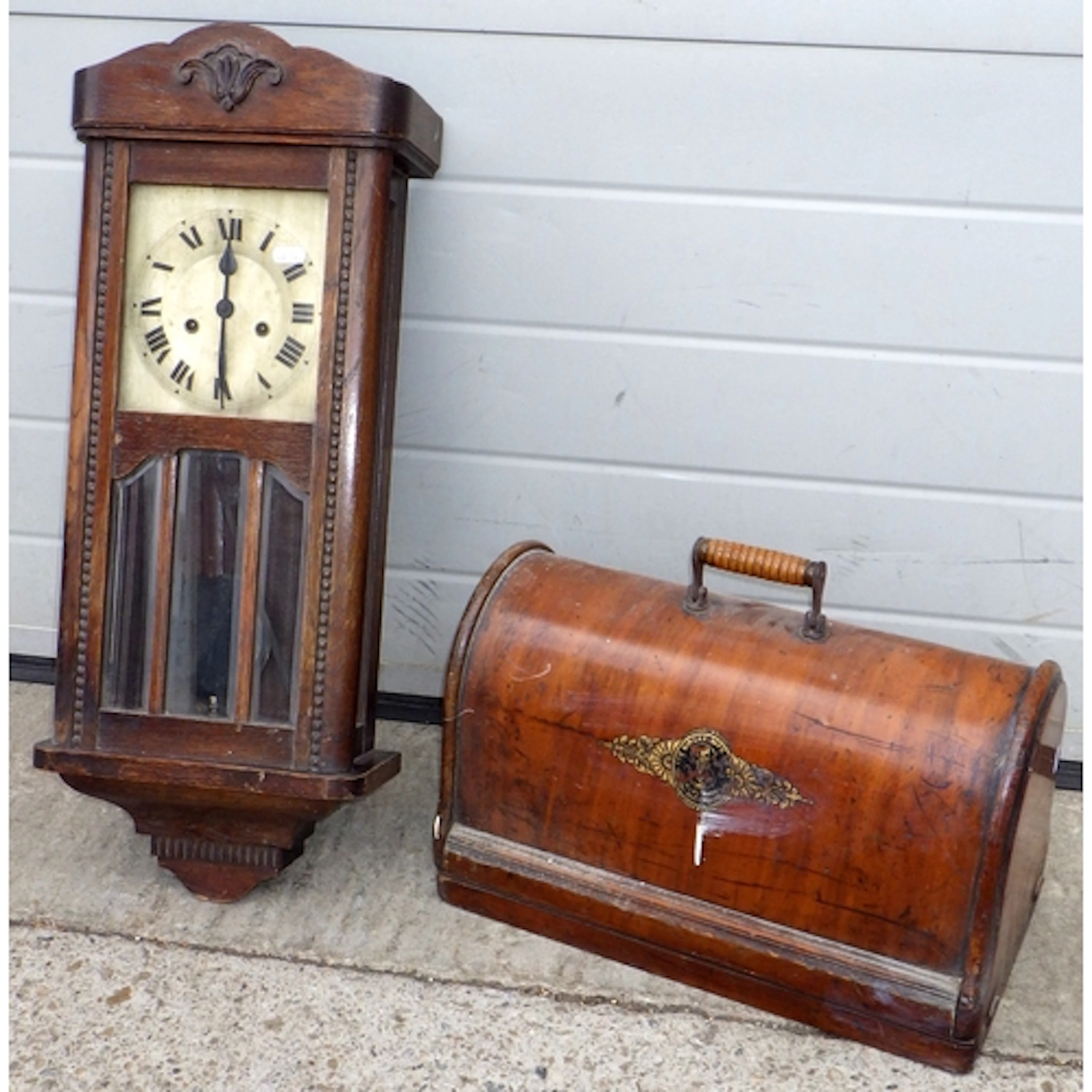 A drop dial wall clock together with a cased sewing machine,...