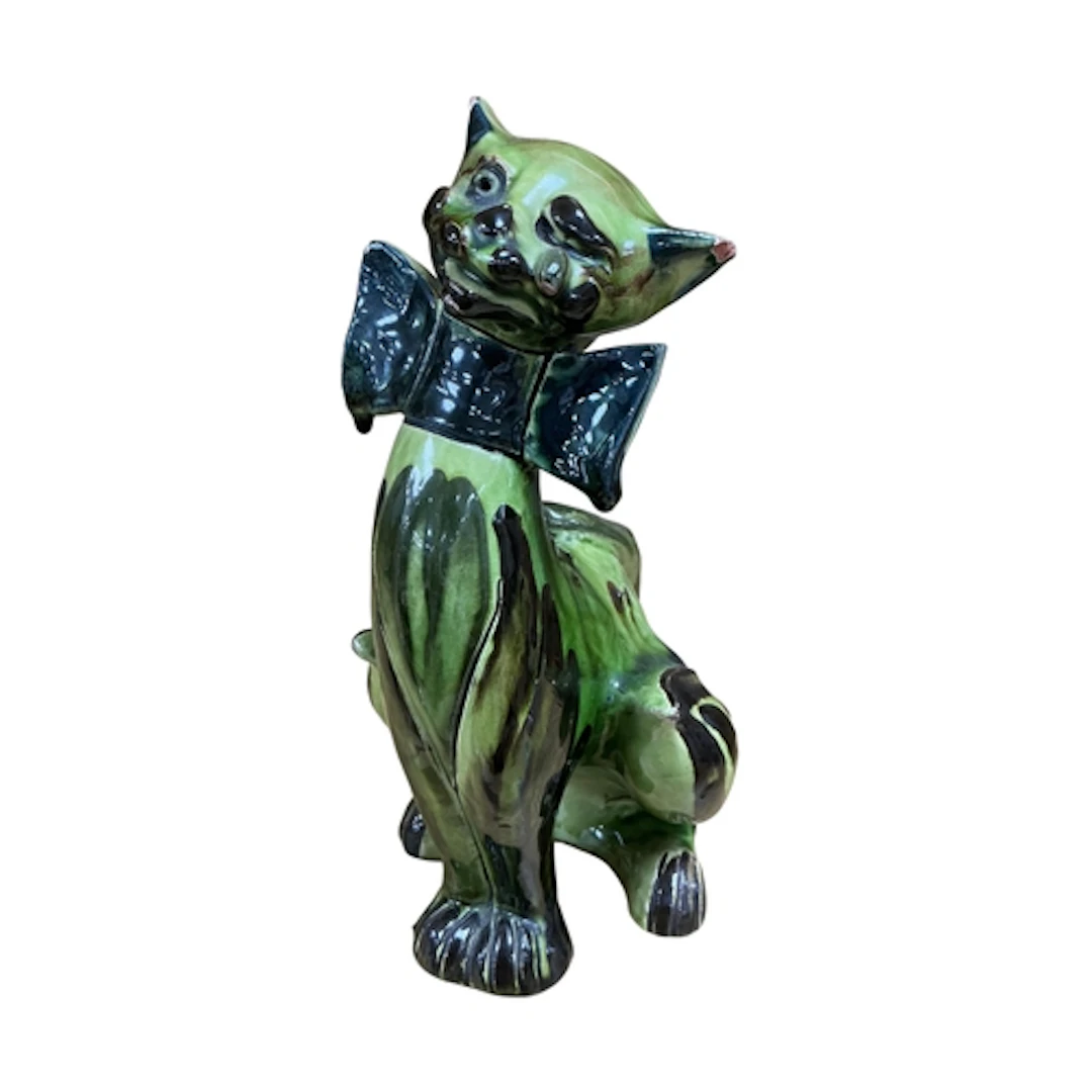 A C.H.Brannam green glazed pottery cat modelled seated with ...