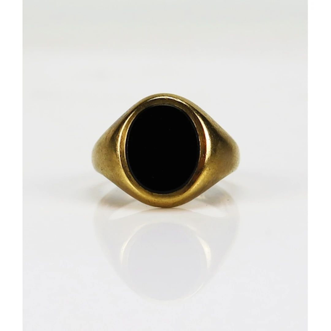 An onyx signet ring in a heavy 9ct gold setting, size O, hal...