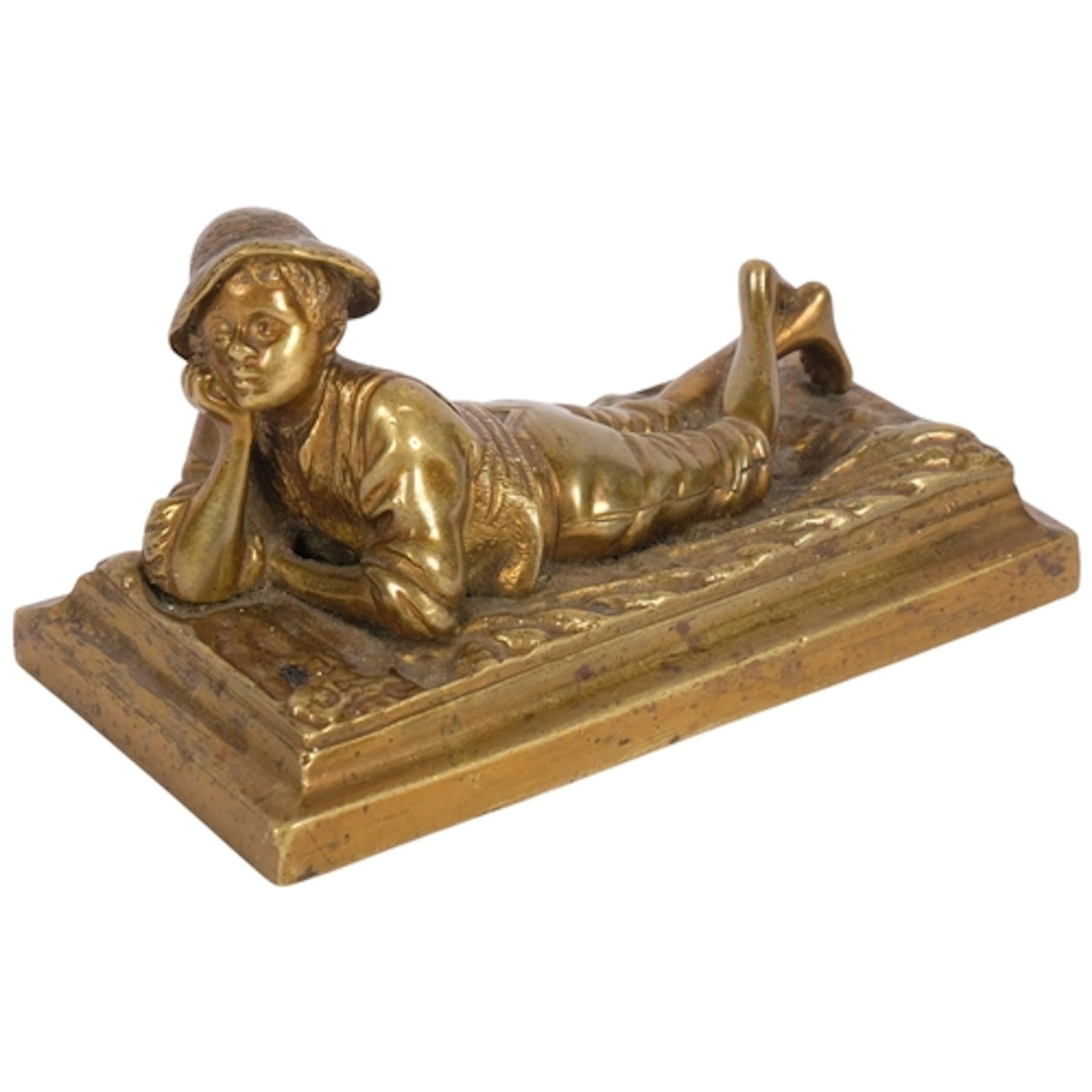 An antique cast bronze figure of a boy lying in a field, no ...