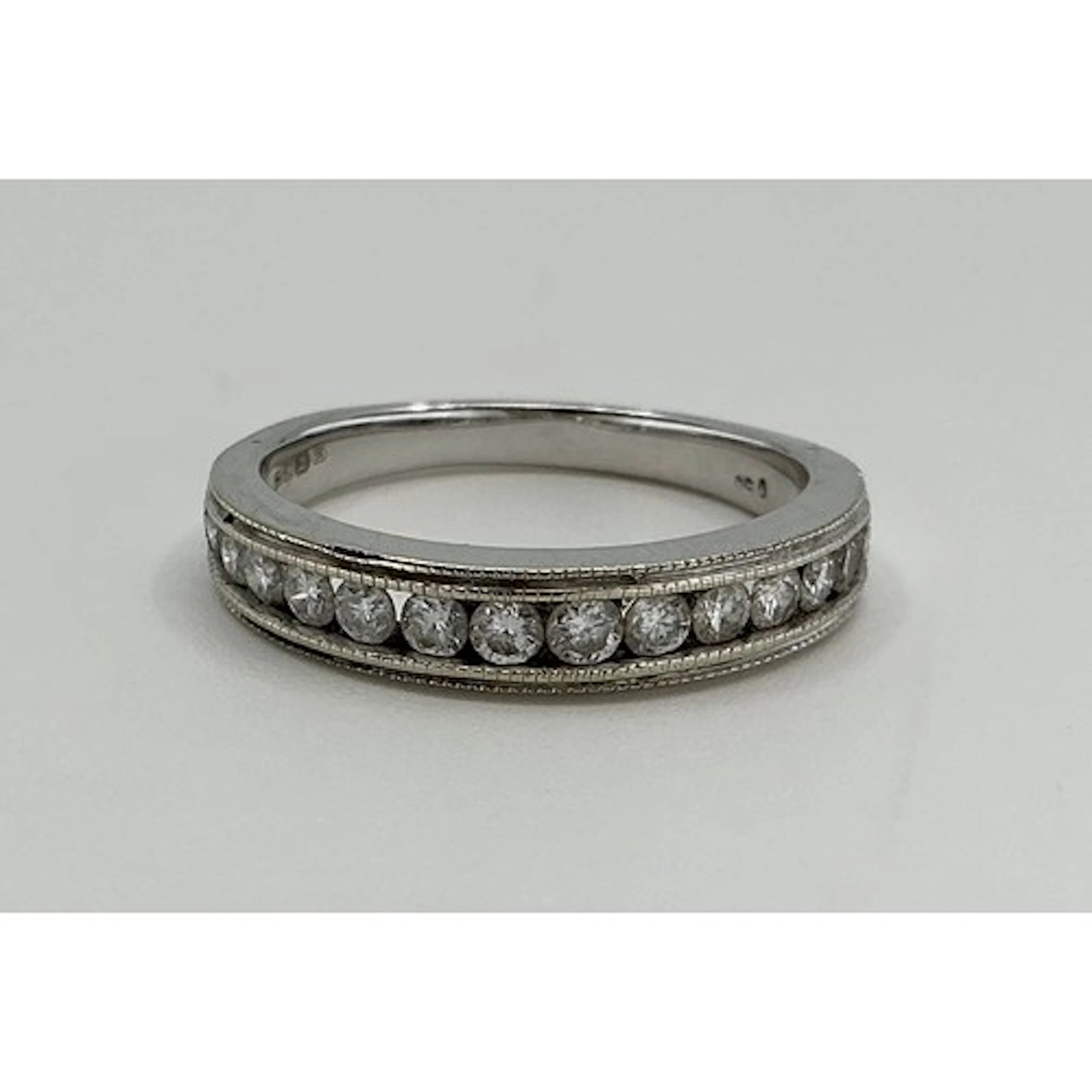 A diamond half eternity ring, channel set with fourteen roun...