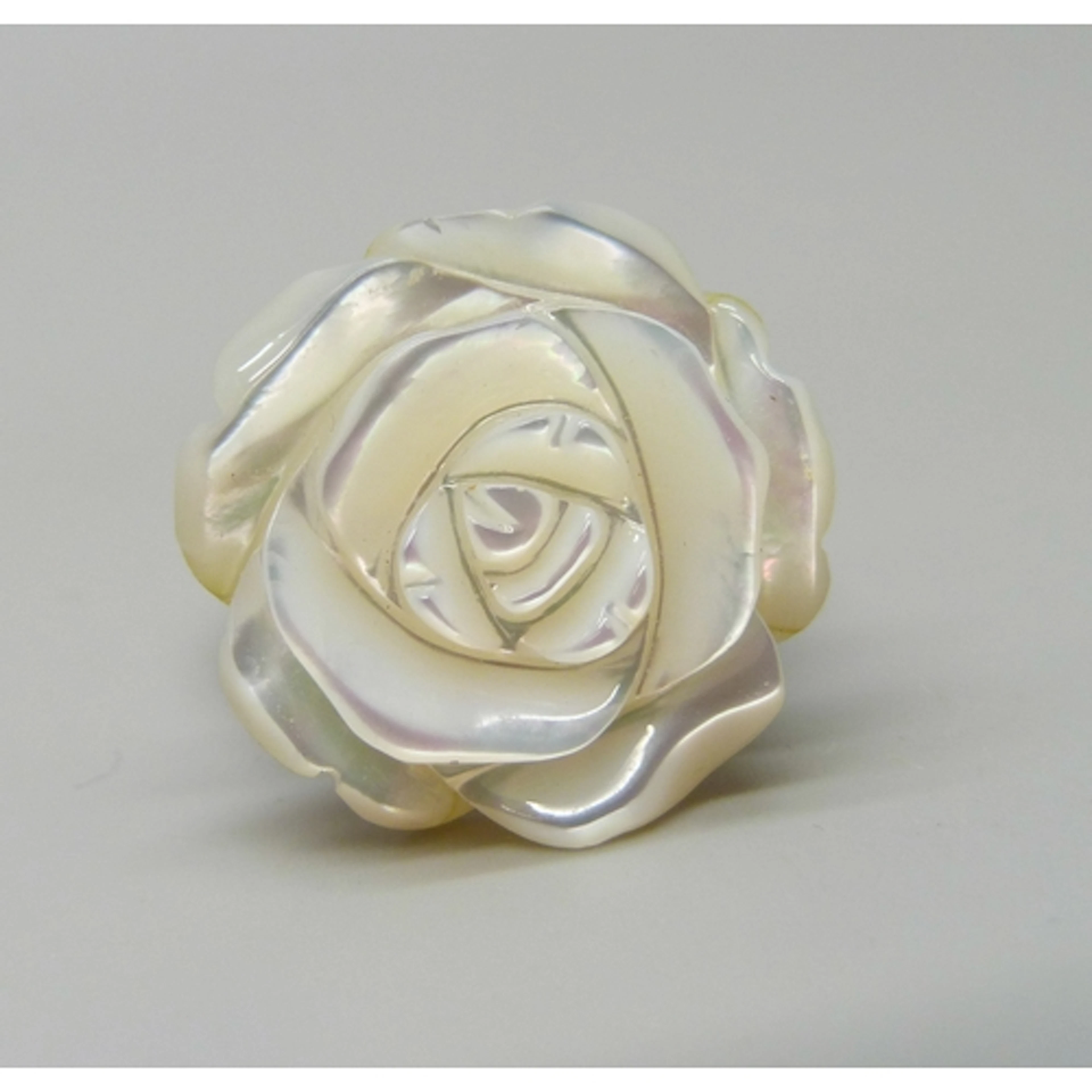 Whitney Kelly, a silver a carved mother of pearl flower desi...