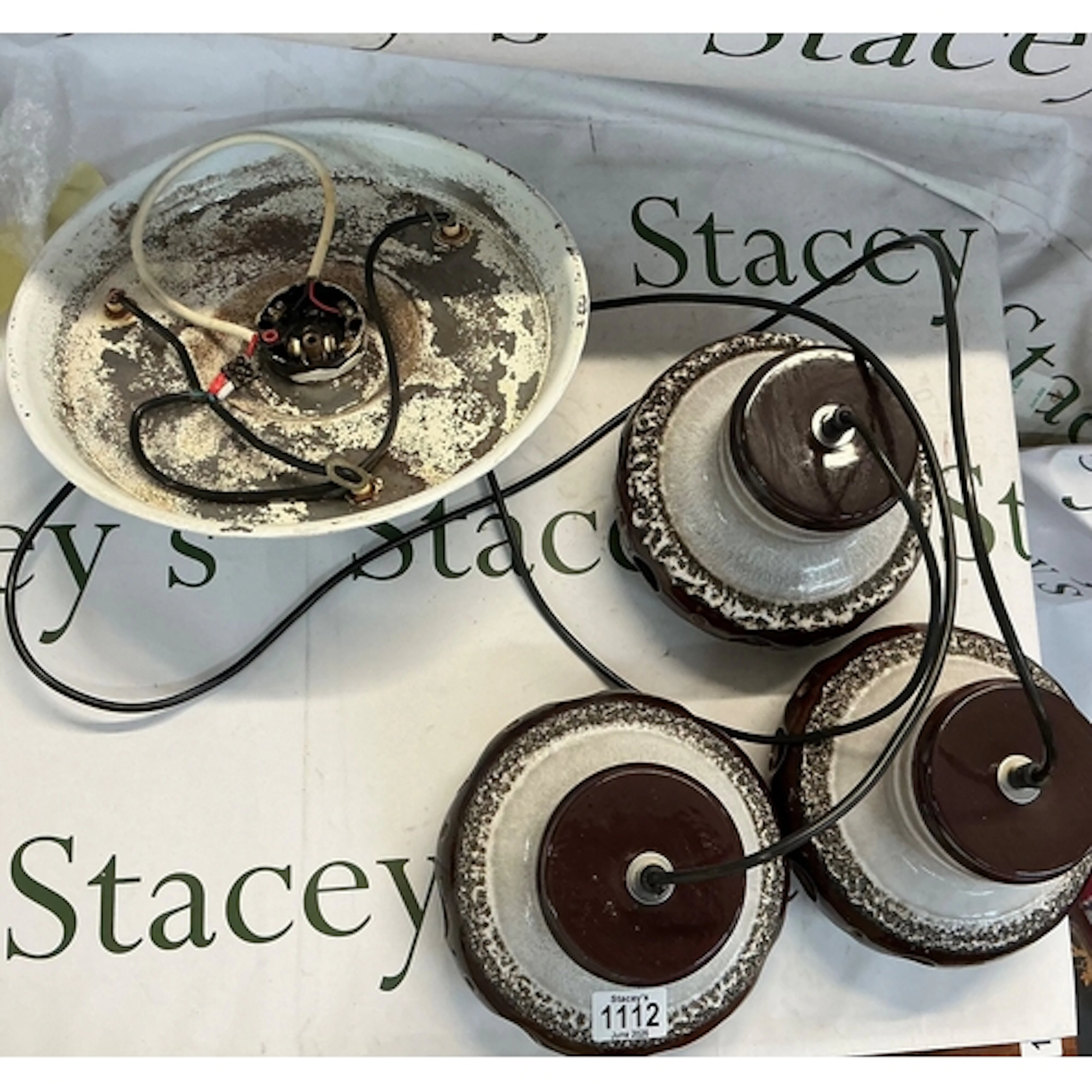 Three identical ceramic German wall lights featuring a class...
