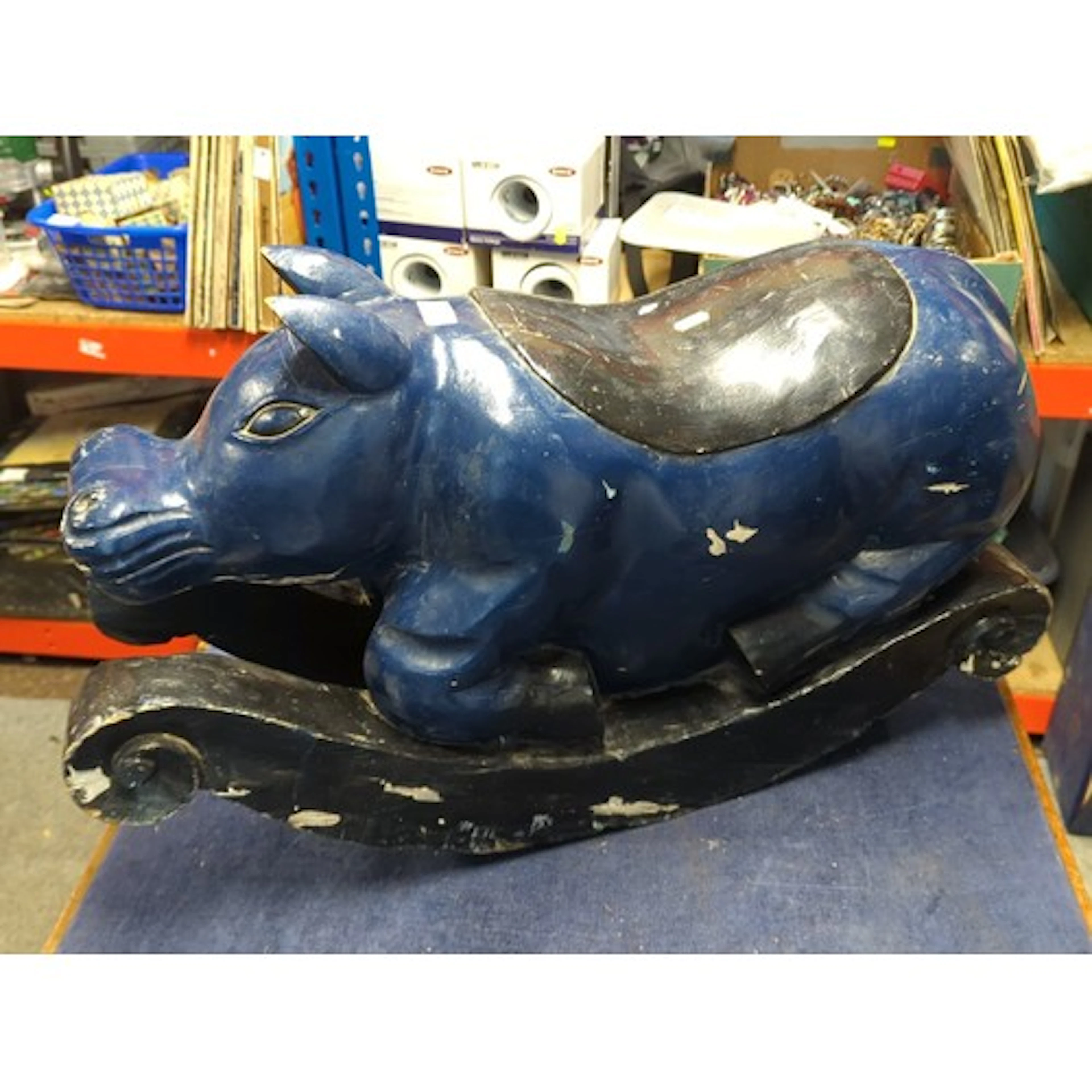 A carved wooden hippo-form rocking toy, painted dark blue wi...