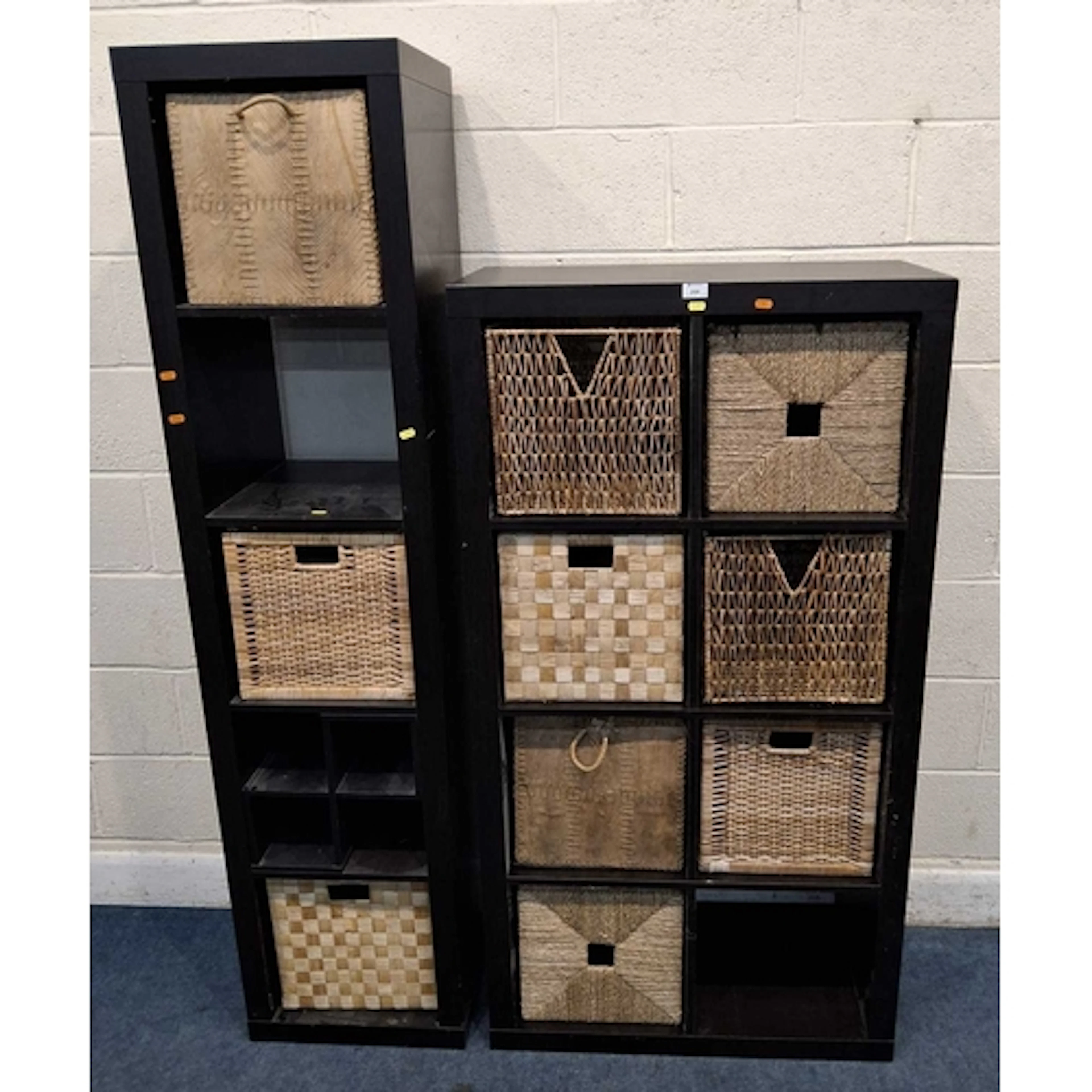 TWO BLACK IKEA STORAGE UNITS, each with a variety of boxes ...