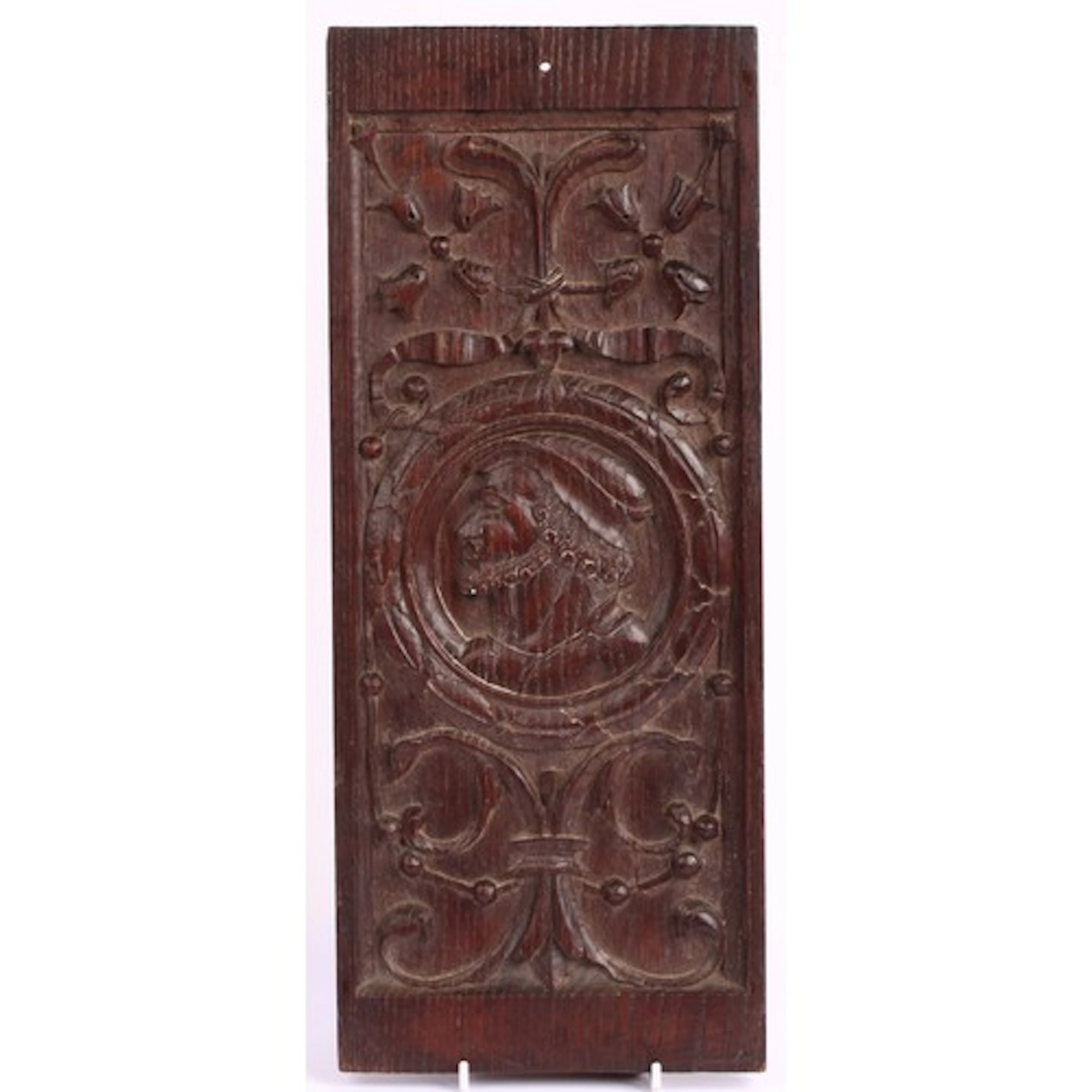 A North European oak Romayne panel, carved with a bust-lengt...