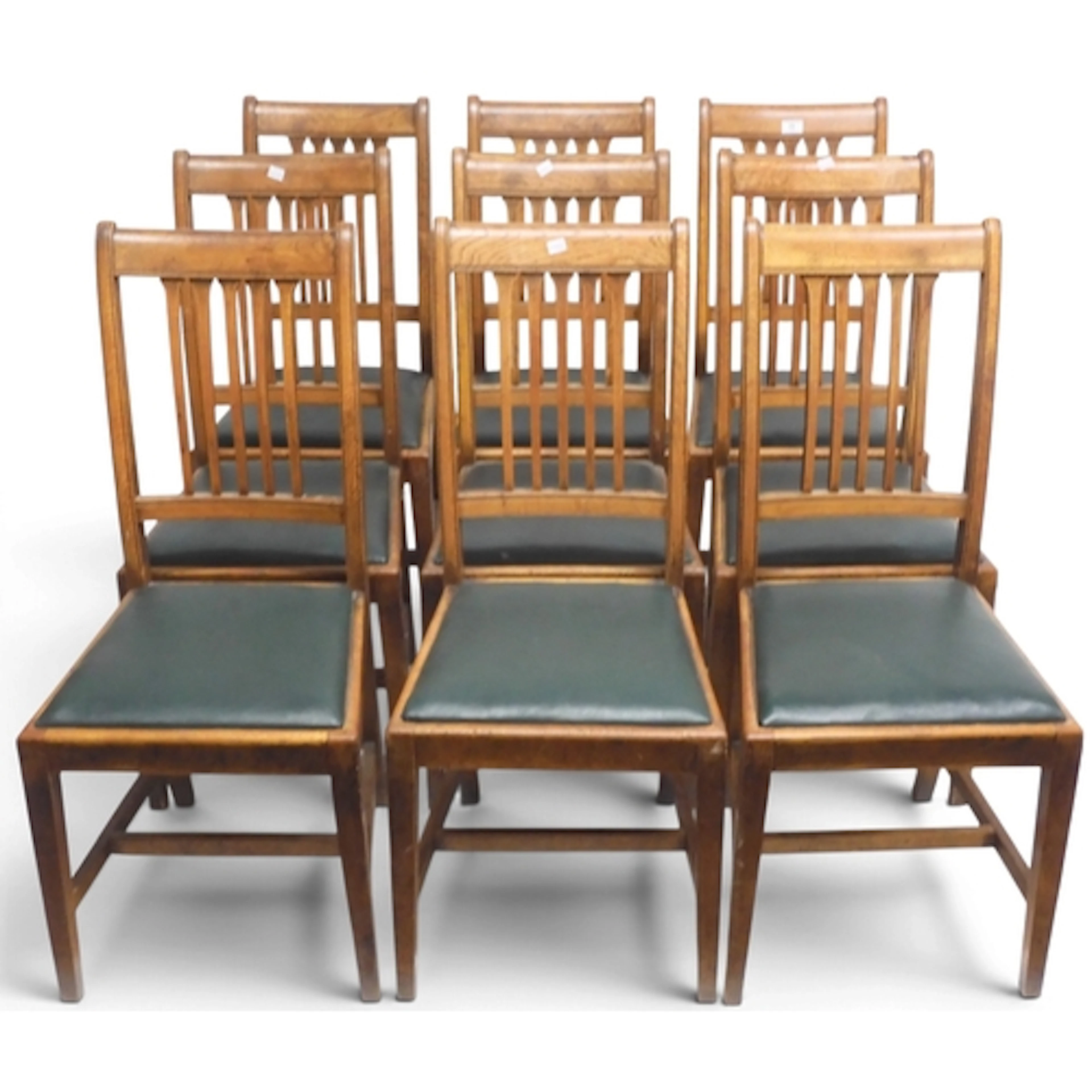 A set of nine late 19th century oak rail back dining chairs ...