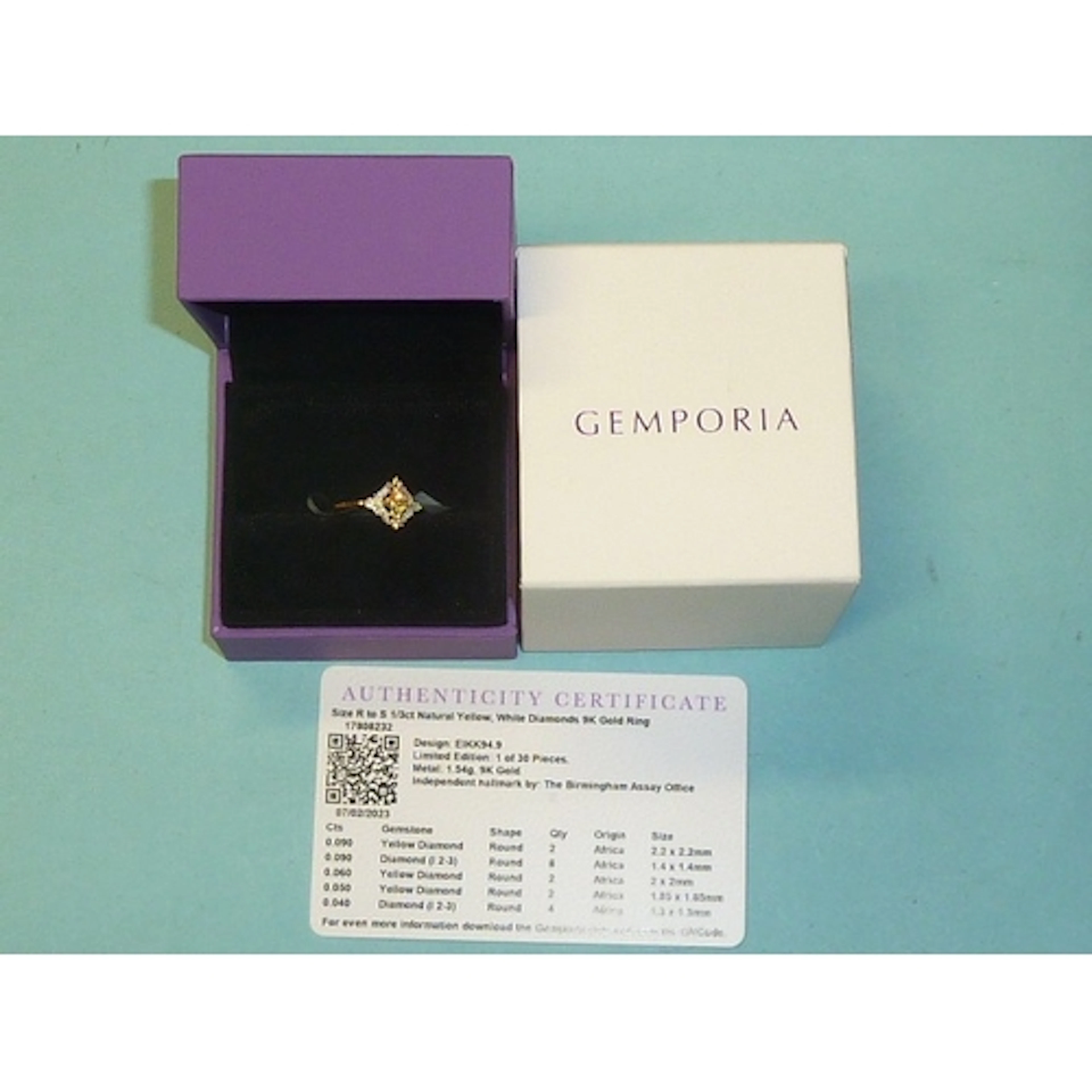 Gemporia, a 9K yellow gold diamond cluster ring set a square...