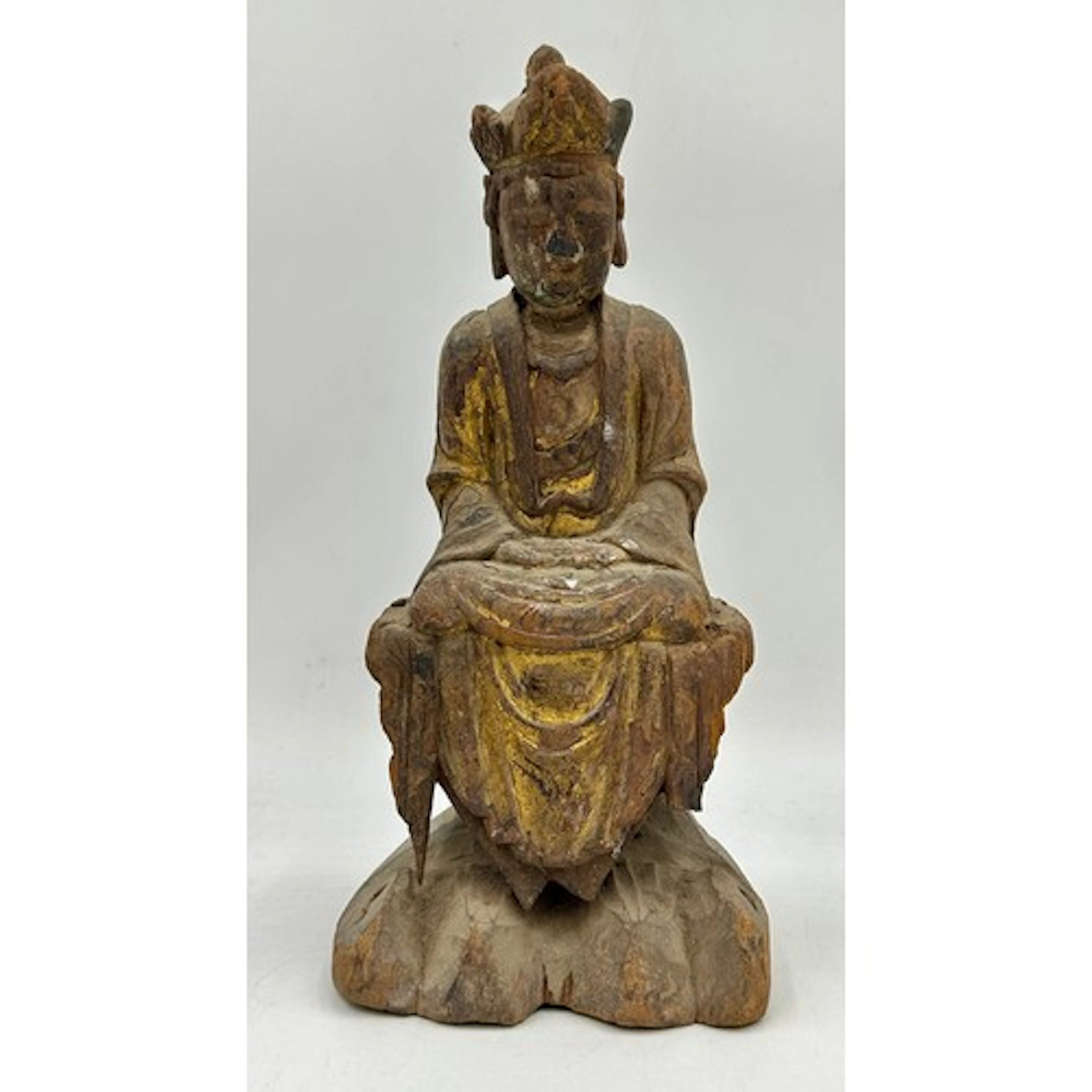 A carved wood figure of a seated Guanyin, probably Ming dyna...