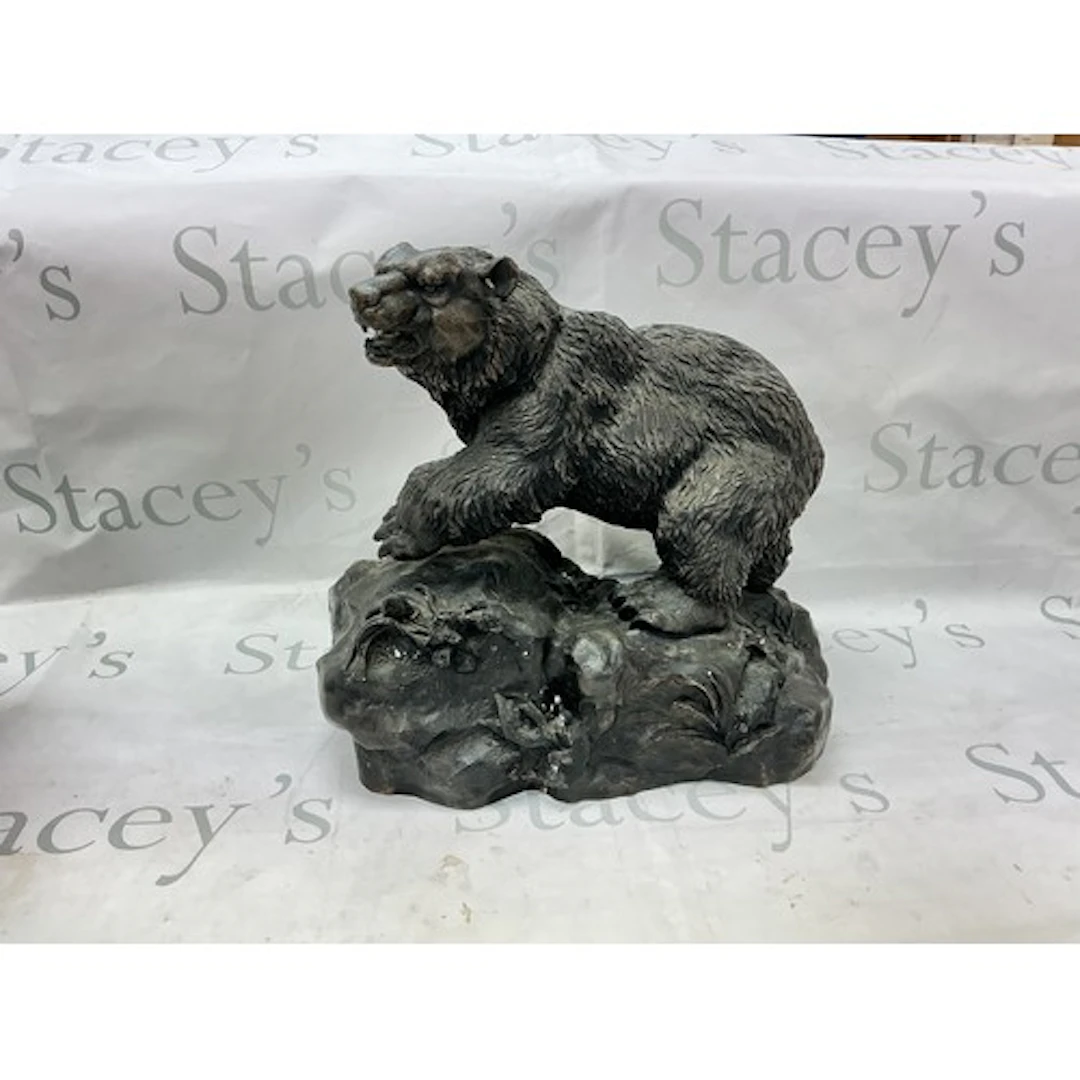 A cast bronze figure of a bear.