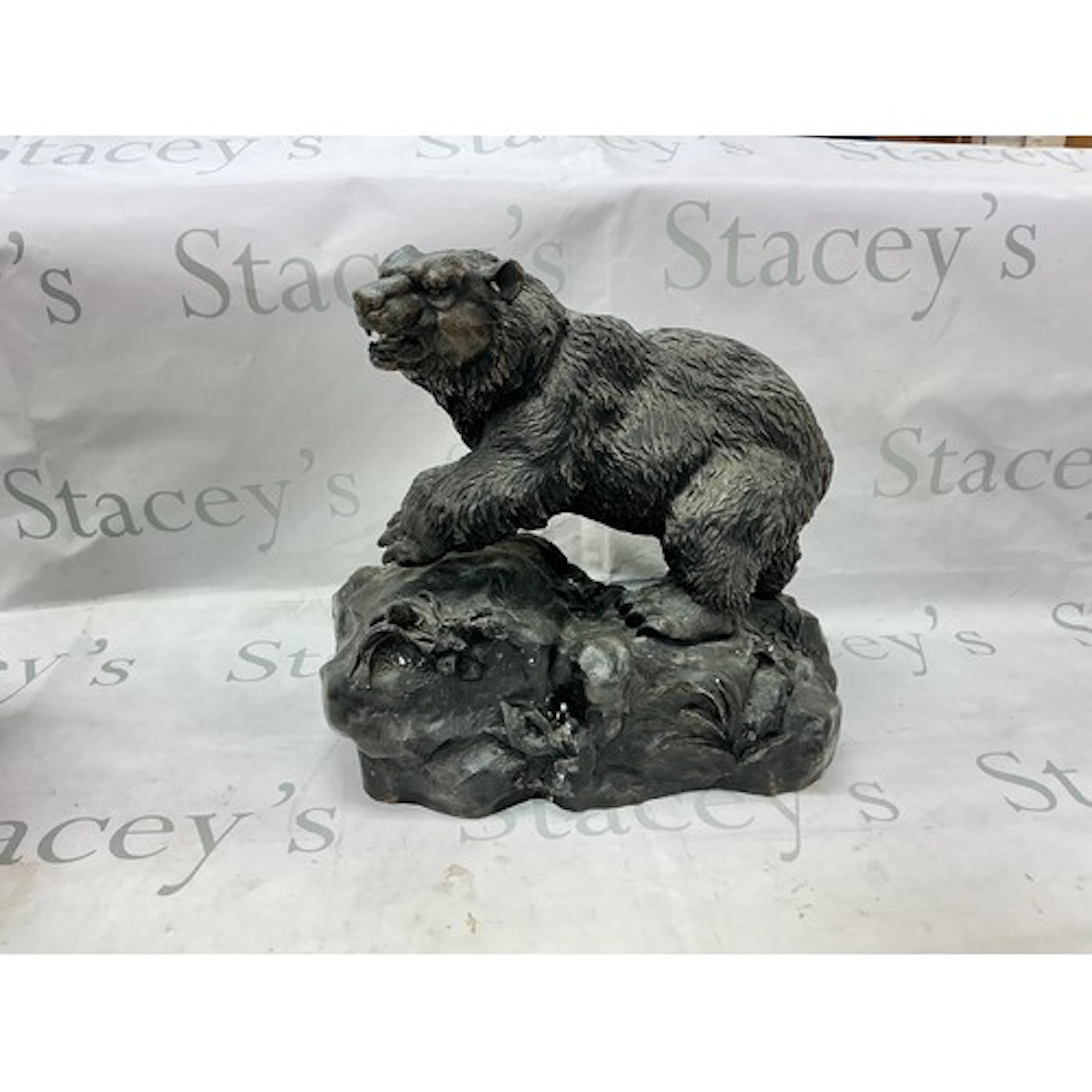 A cast bronze figure of a bear.