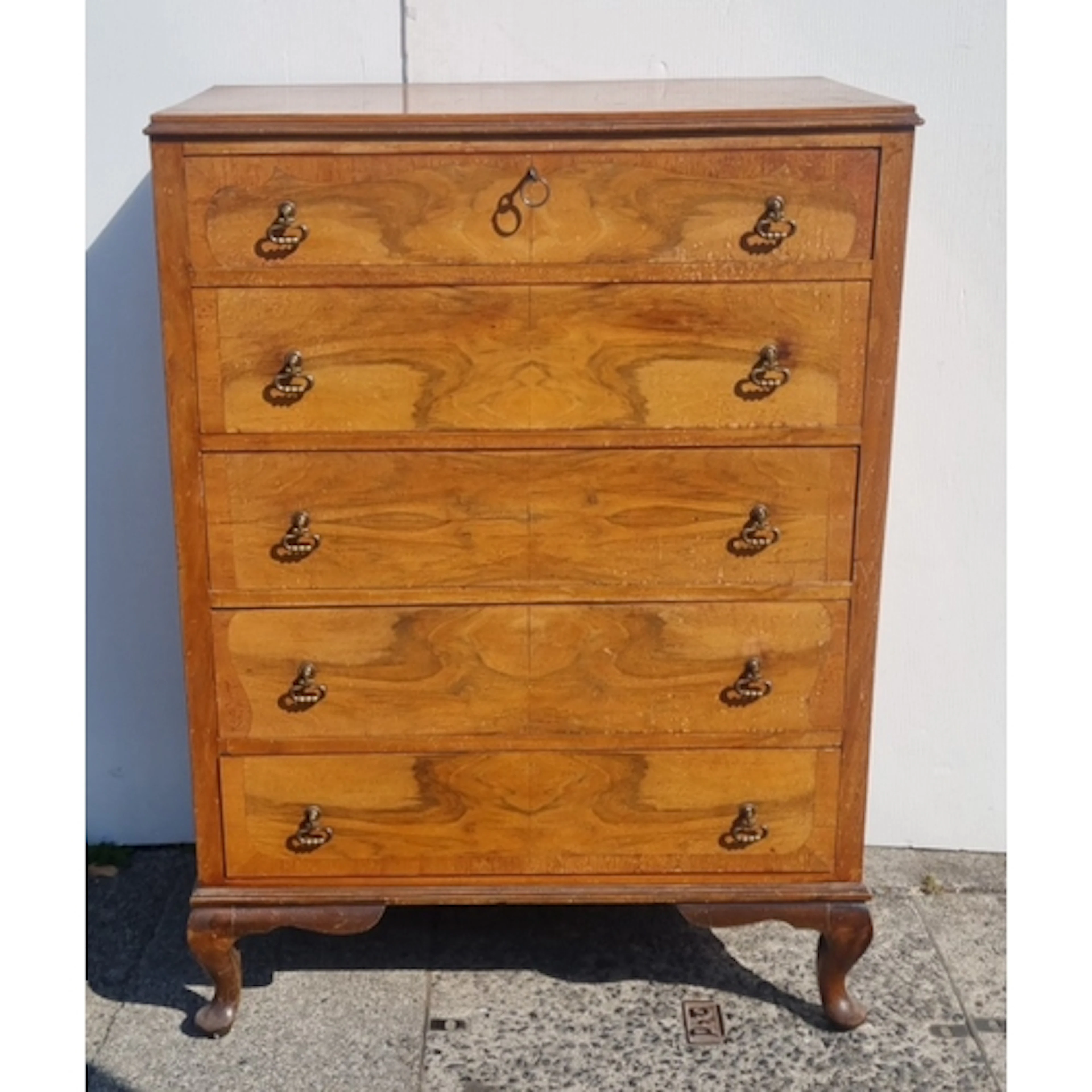 Walnut-type five-drawer chest with figured drawer fronts, br...