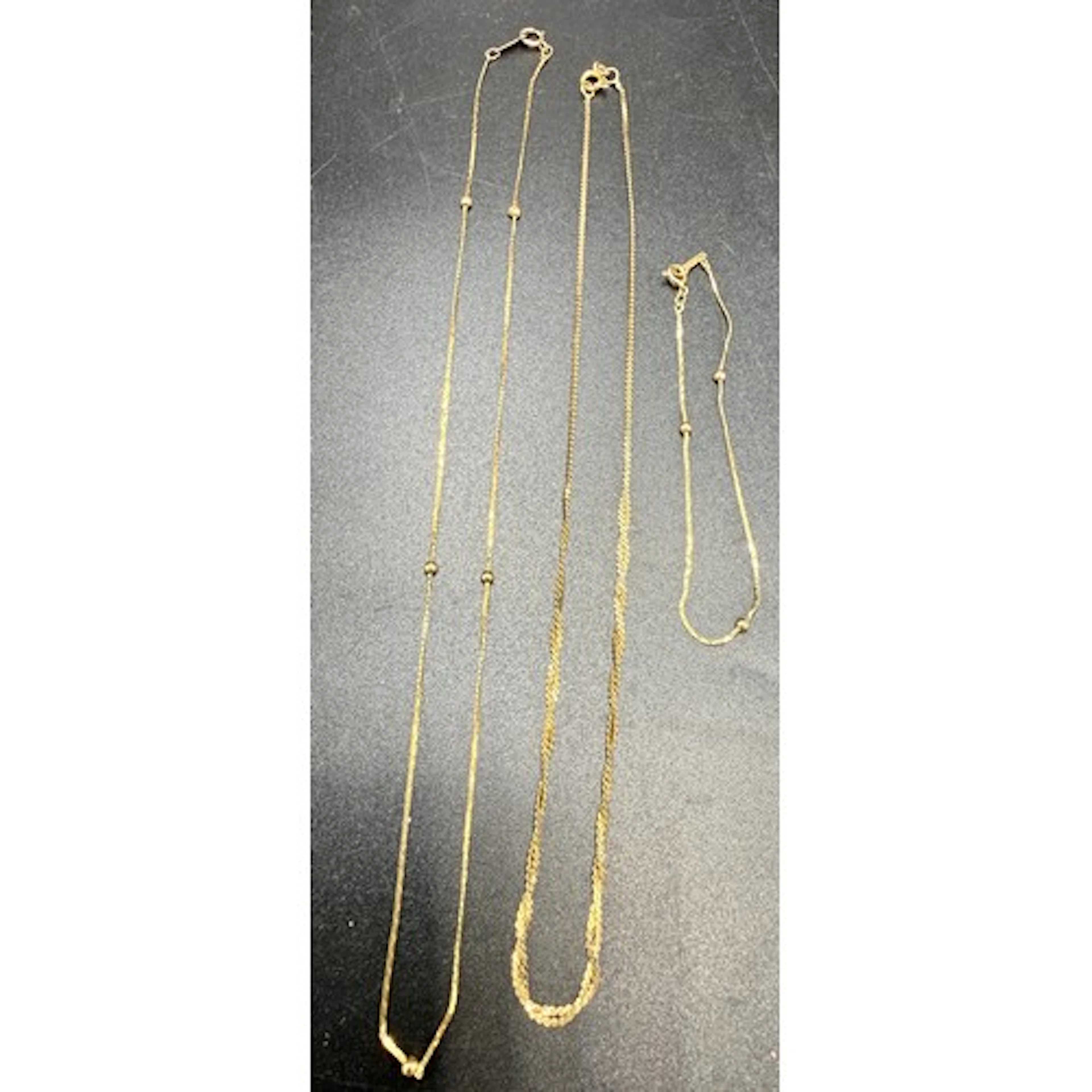 Two 9 carat gold chain necklaces and a bracelet, total weigh...