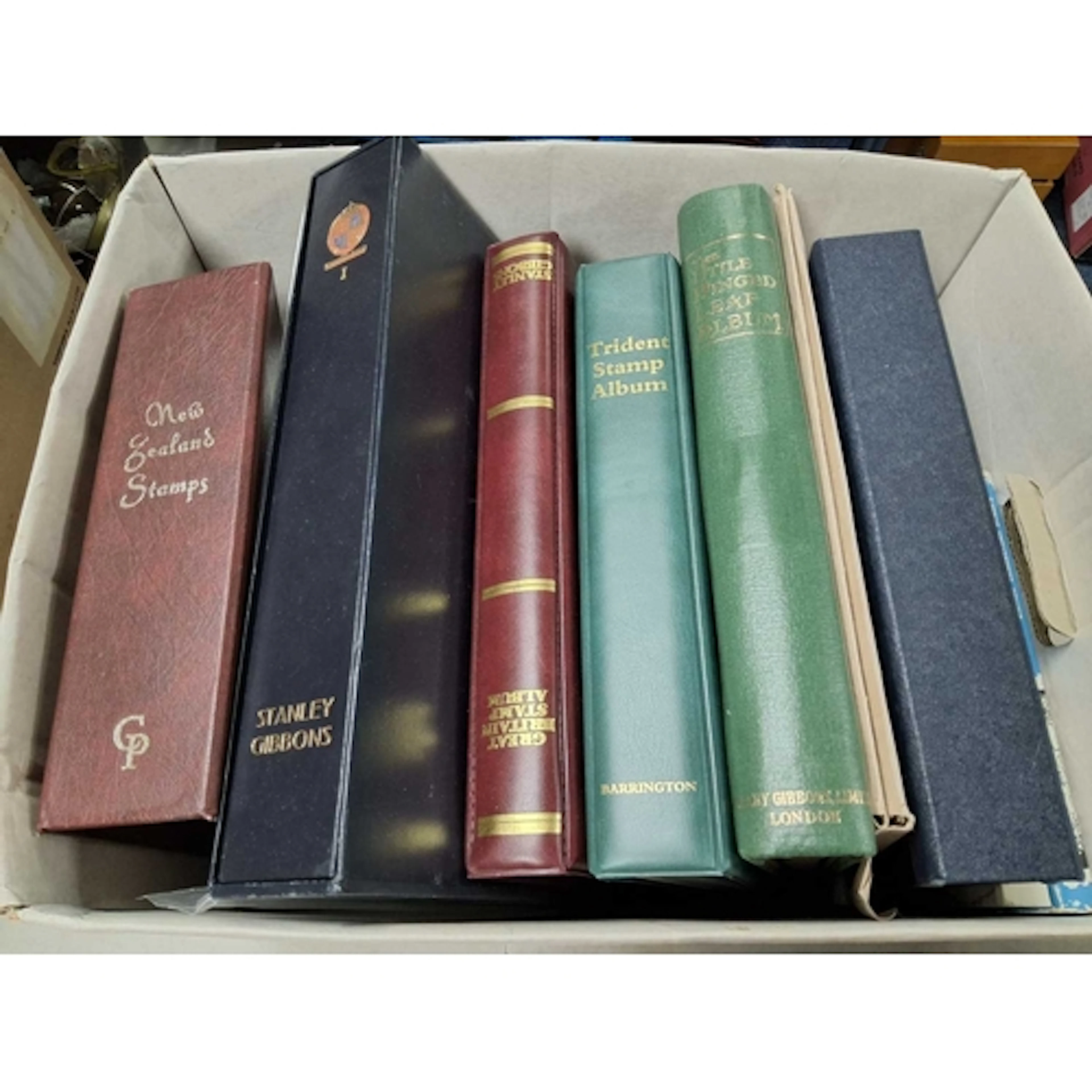 A box of stamp accessories including twin peg albums with un...