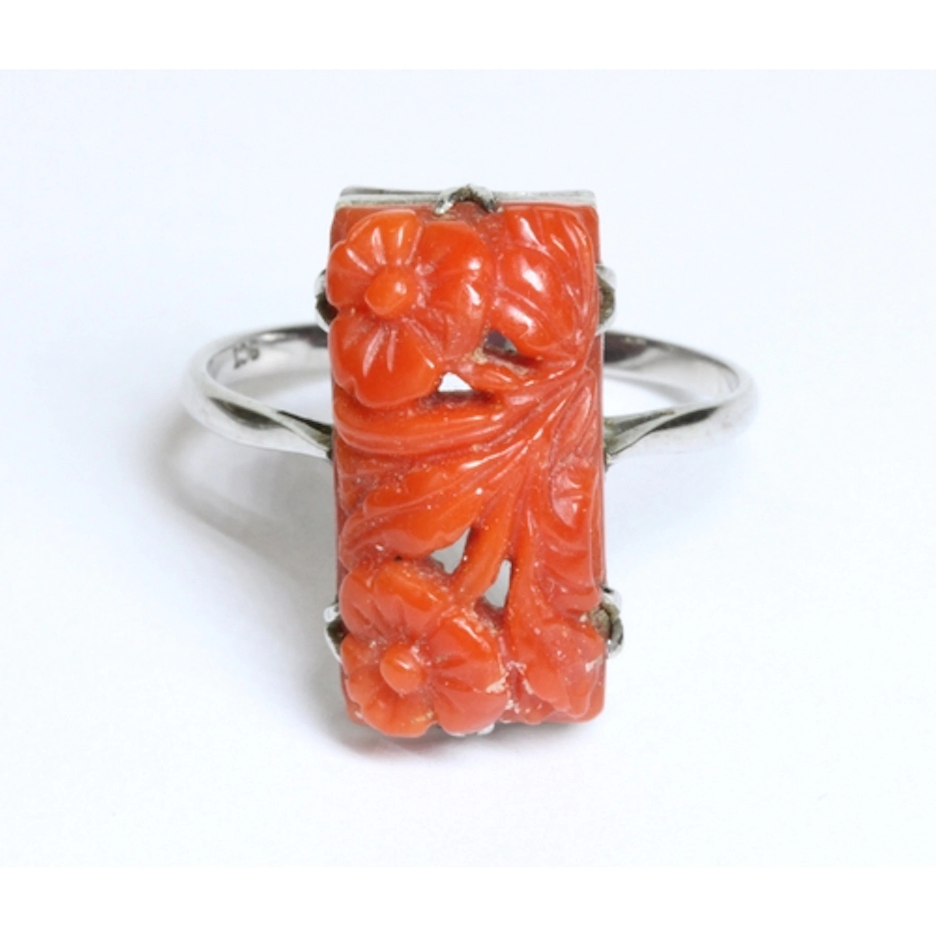 An early 20th century Art Deco style carved coral cabochon r...