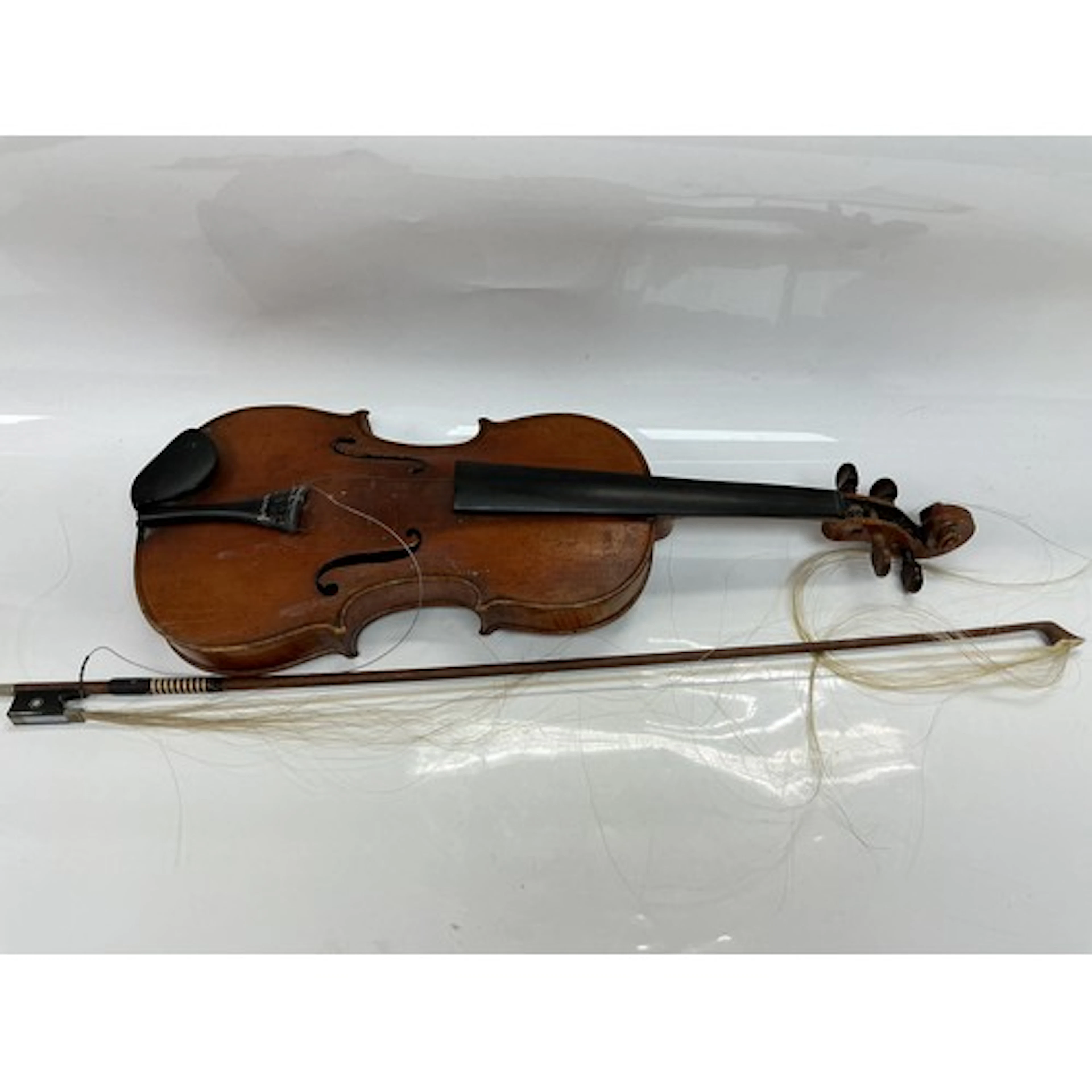 A violin and bow. No label inside soundhole.