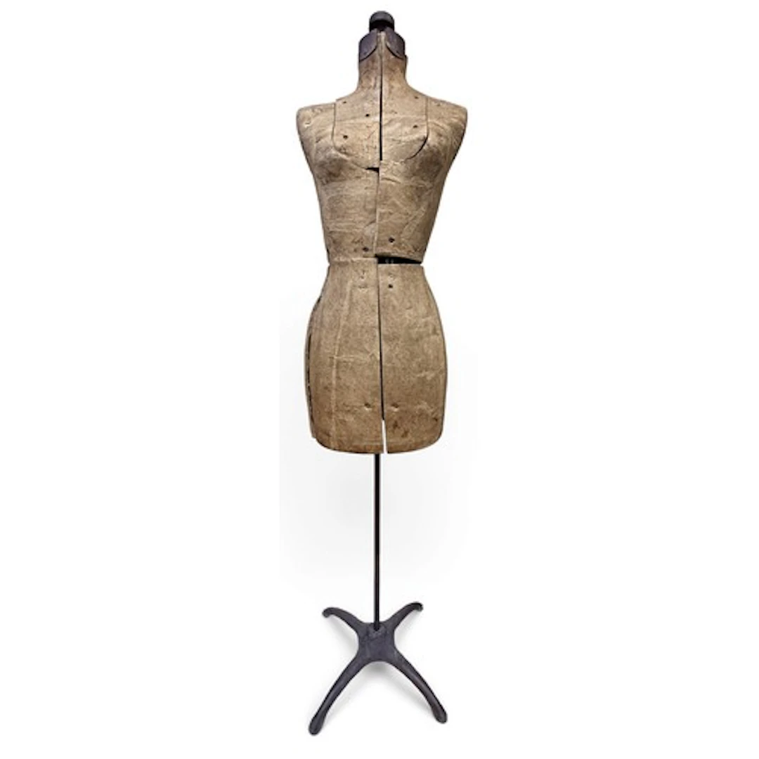 A free-standing American female mannequin, on a weighted x s...