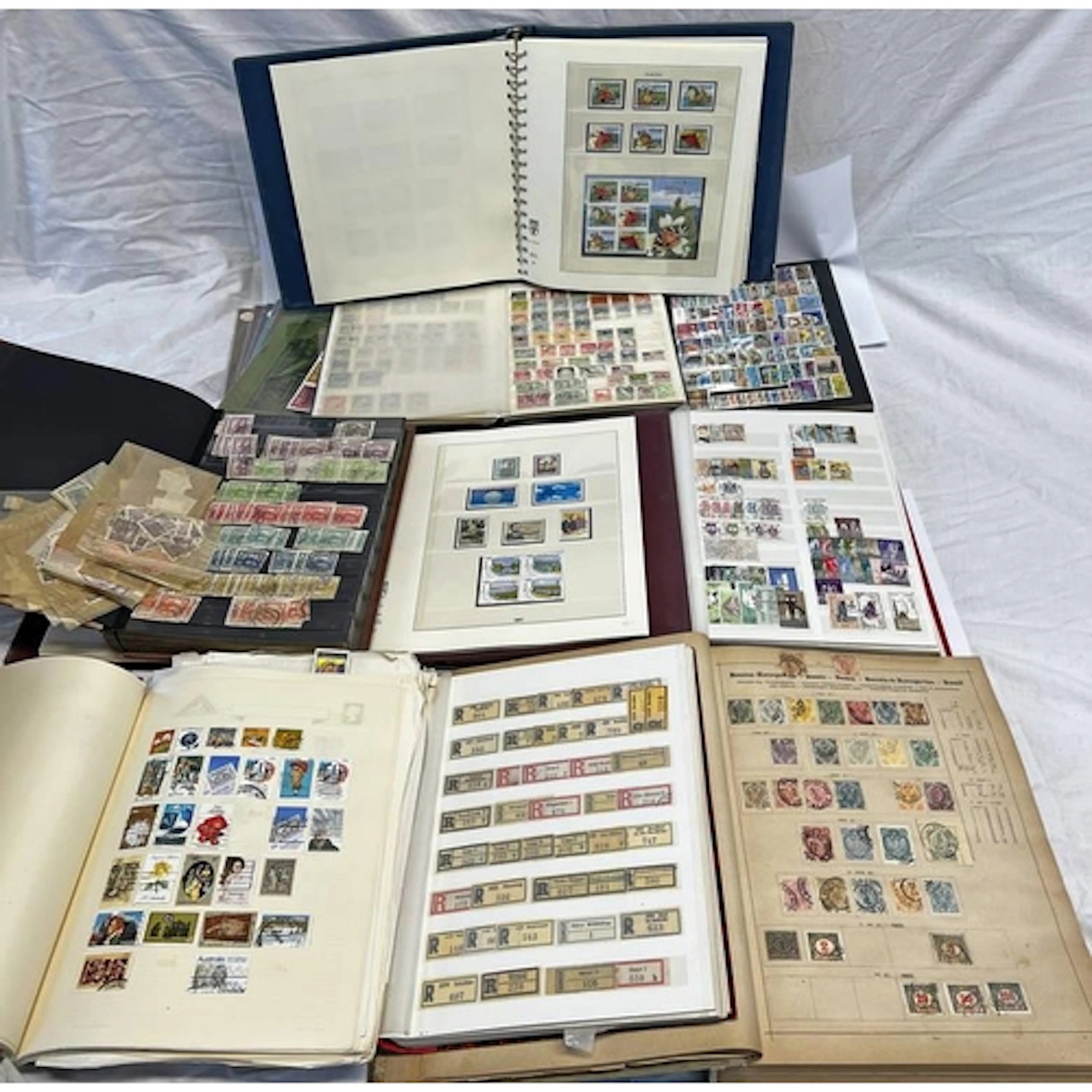 9 STAMP ALBUMS OF WORLD WIDE STAMPS TO INCLUDE GB, GUERNSEY,...