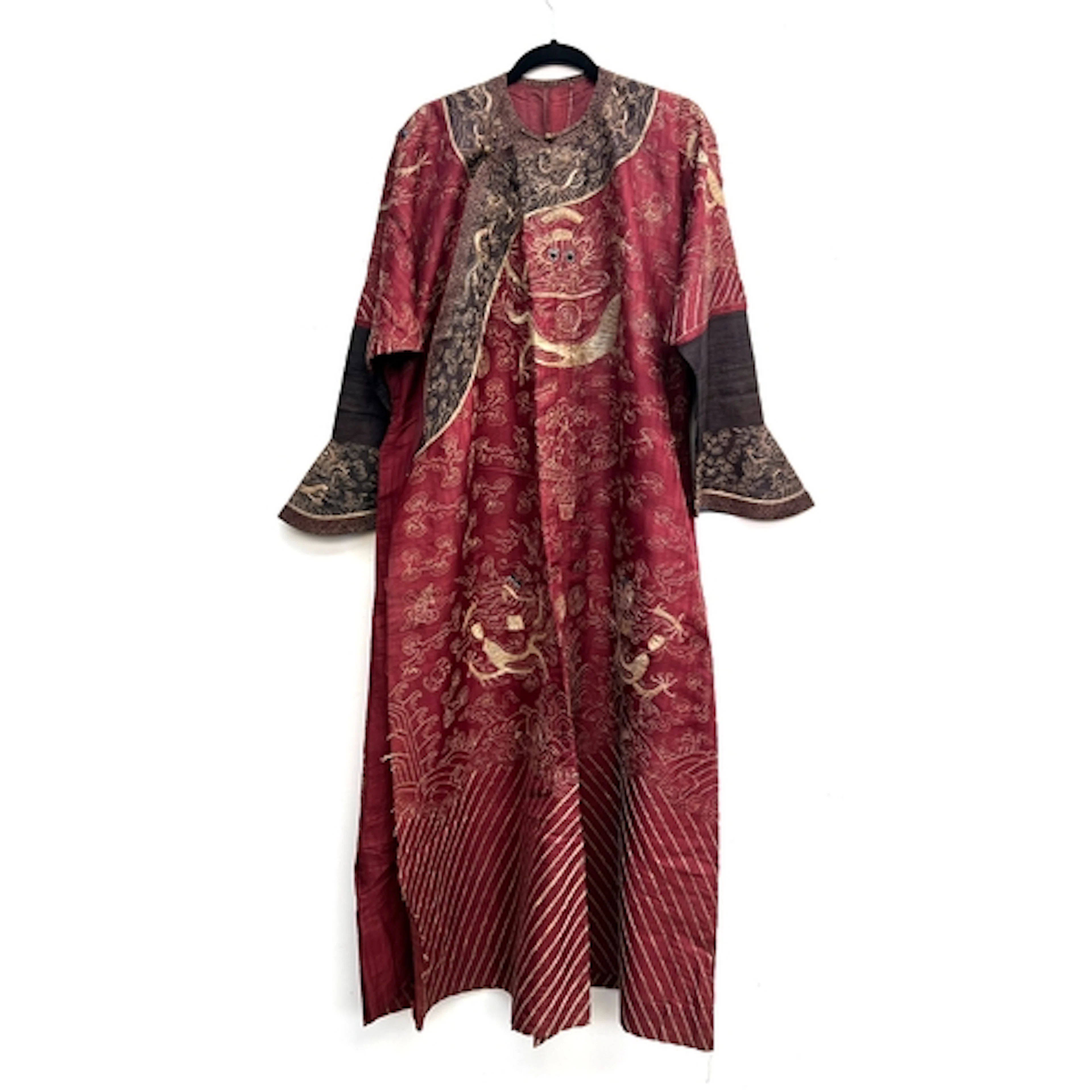 An antique Chinese burgundy silk Jifu dragon robe, central d...