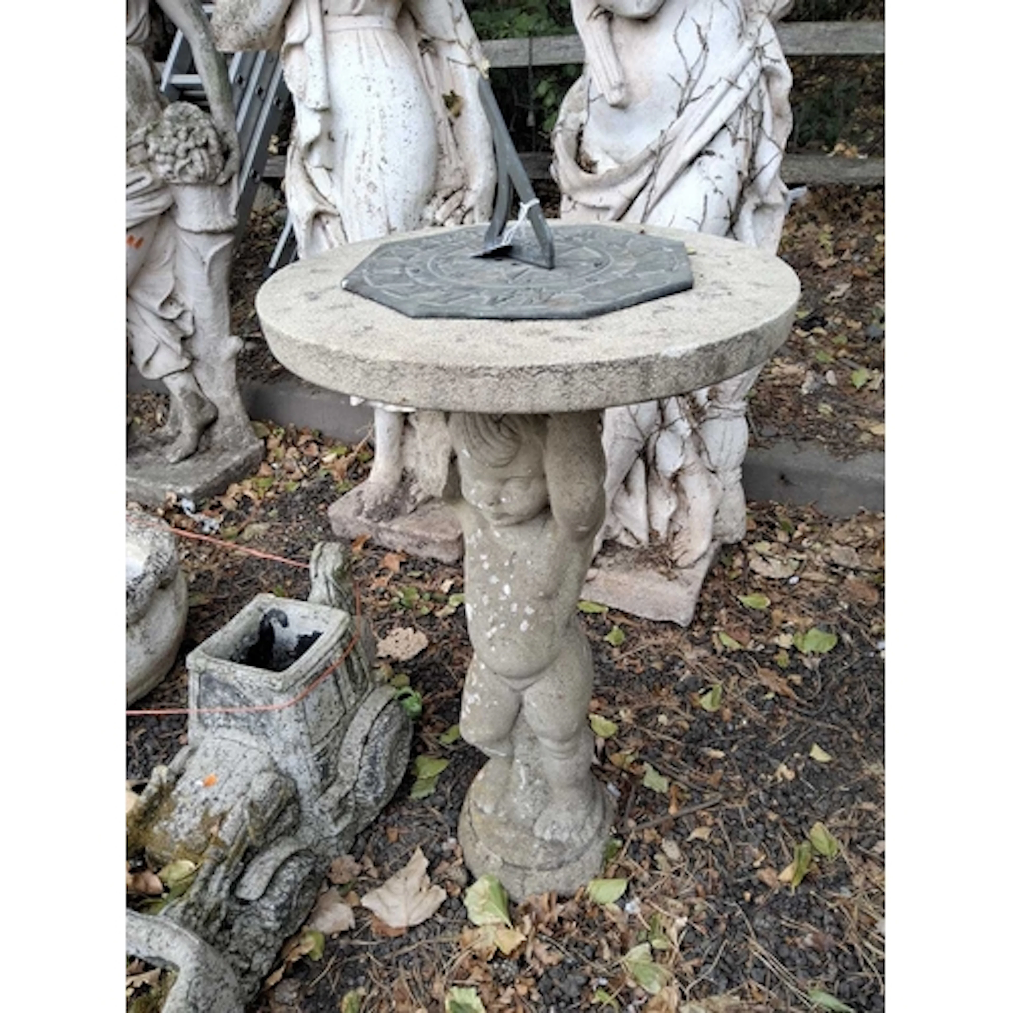 A WEATHERED CONCRETE SUN DIAL, the circular top with a brass...