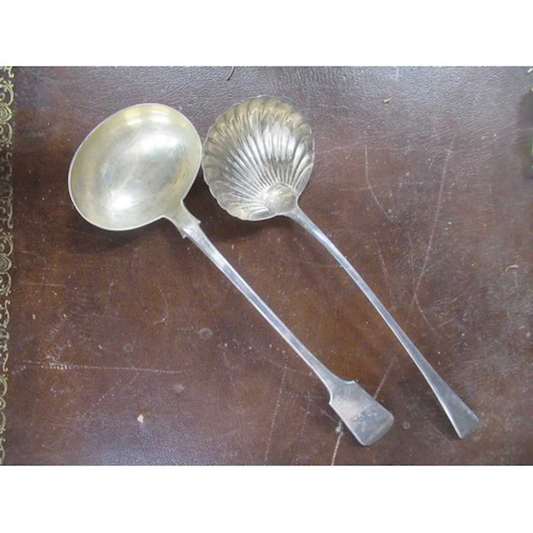 Two 19th century silver soup ladles, both engraved with cres...