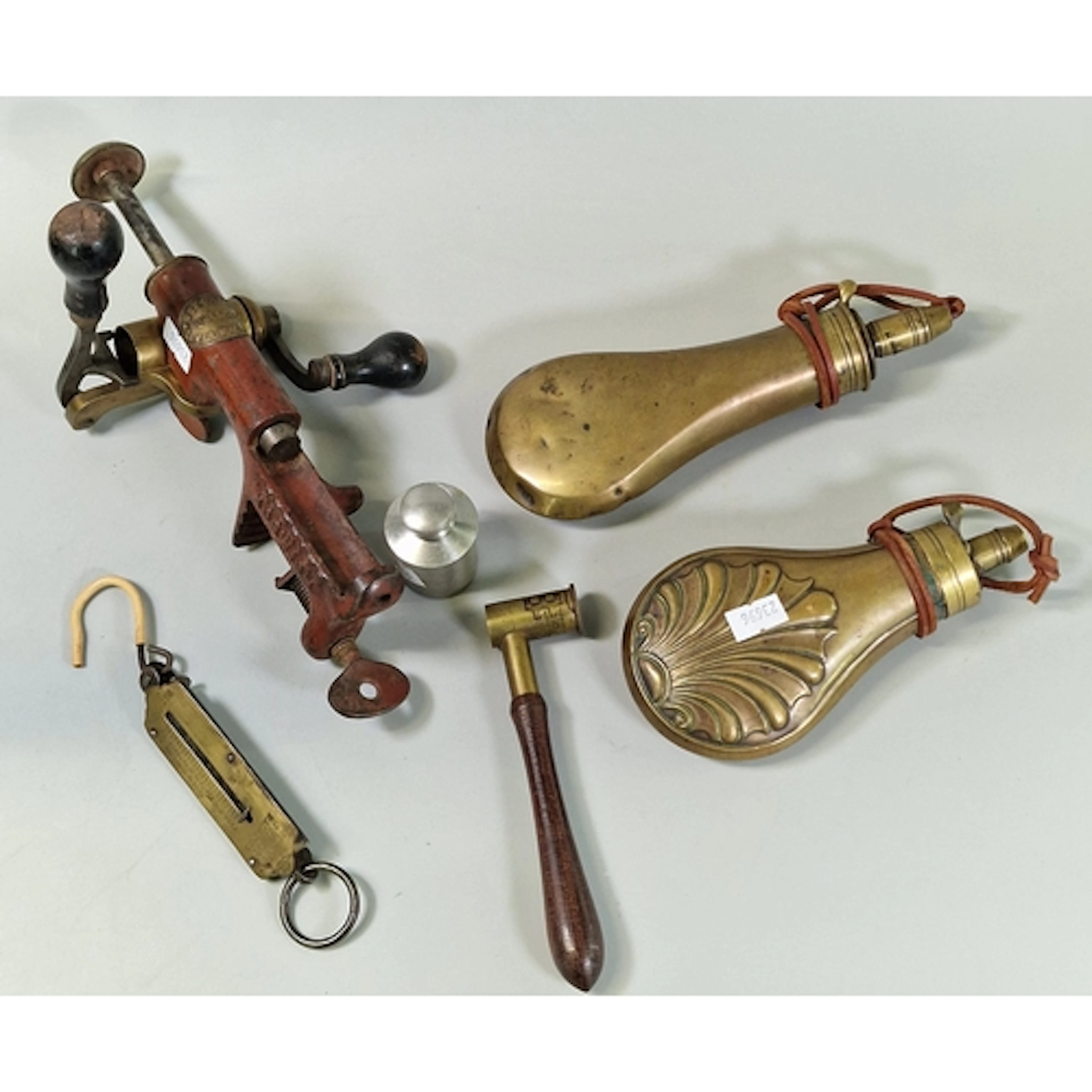 Two brass shot flasks, a powder measure, brass scales, an al...