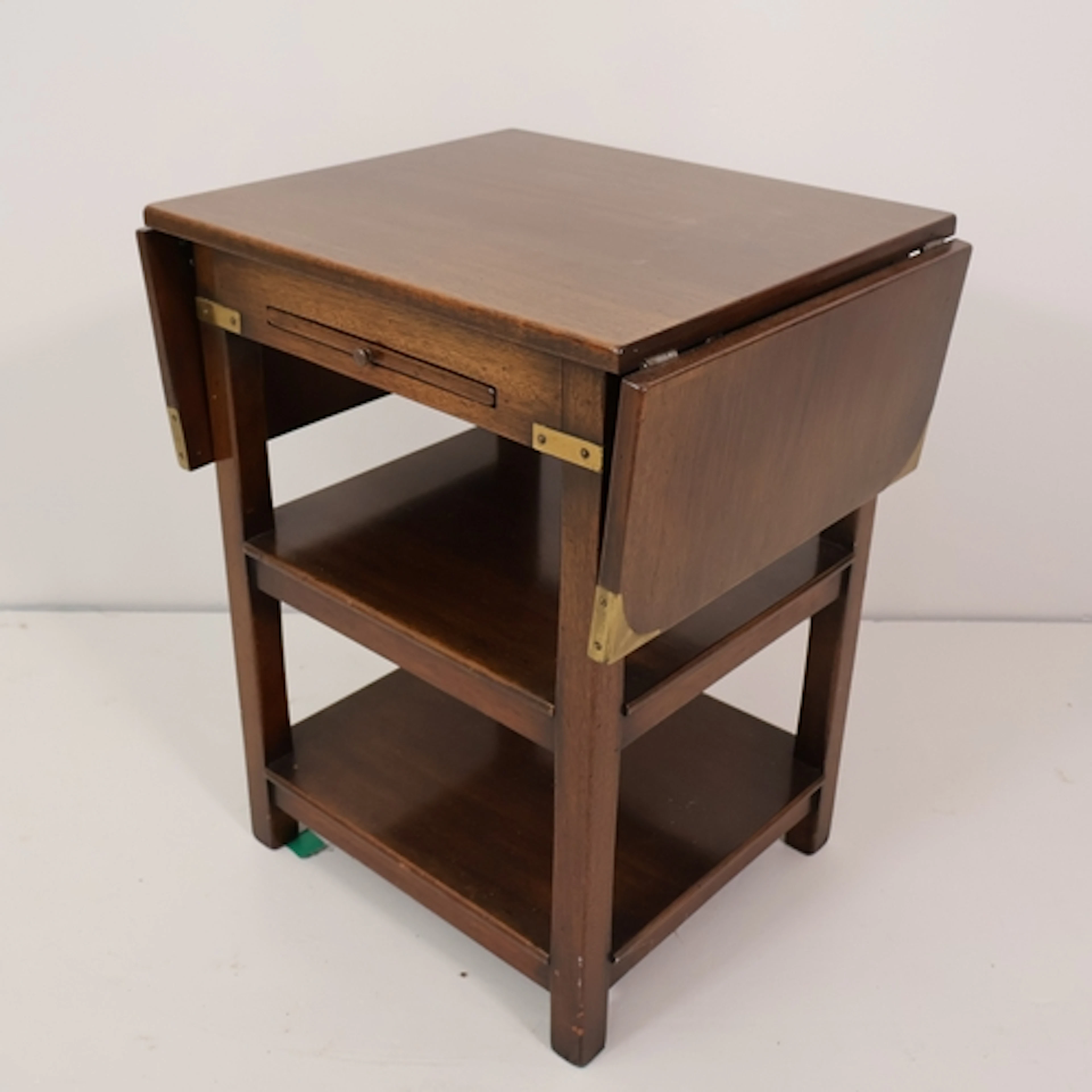An antique oak Campaign style three-tier drop-leaf side tabl...