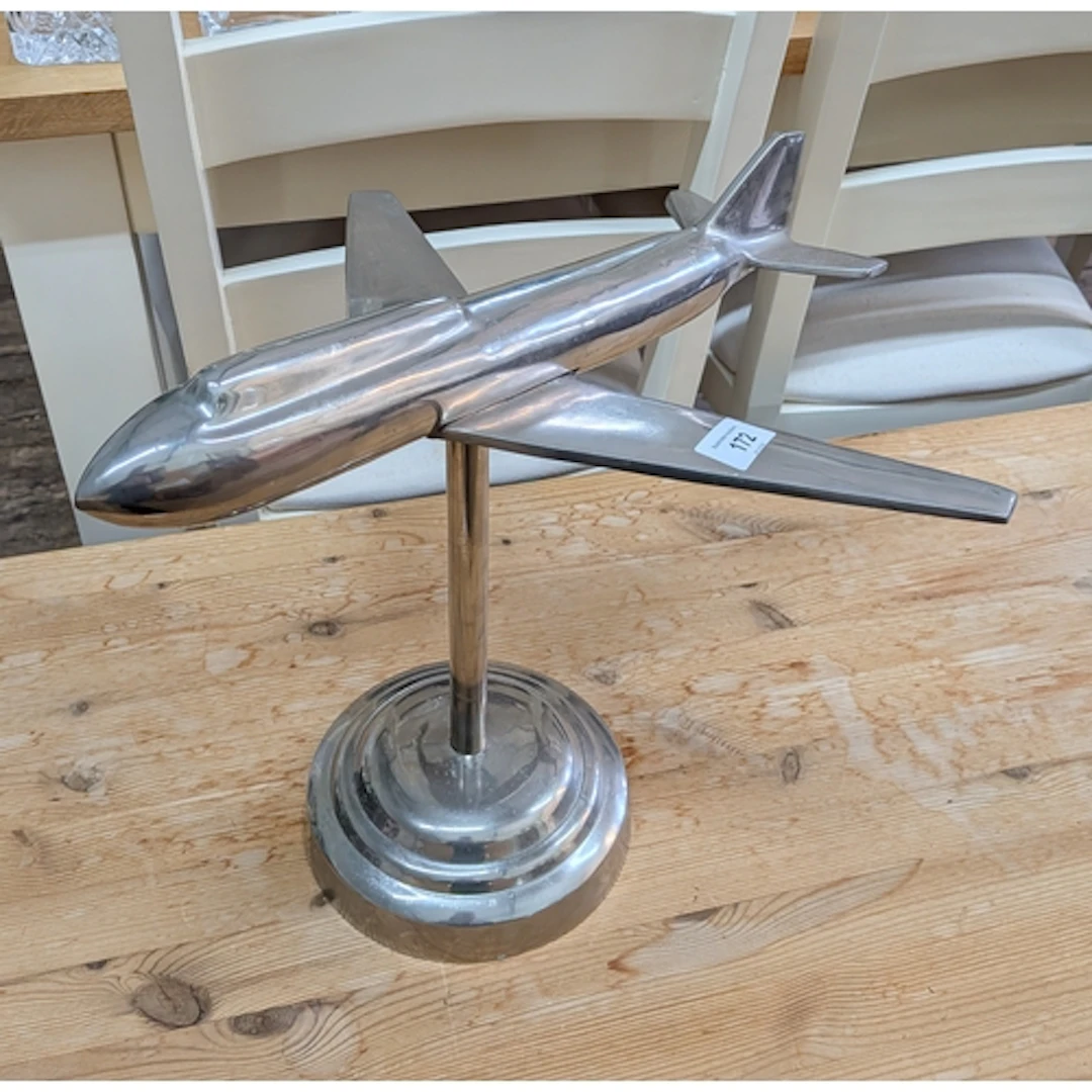A polished aluminium model aeroplane, 17" long