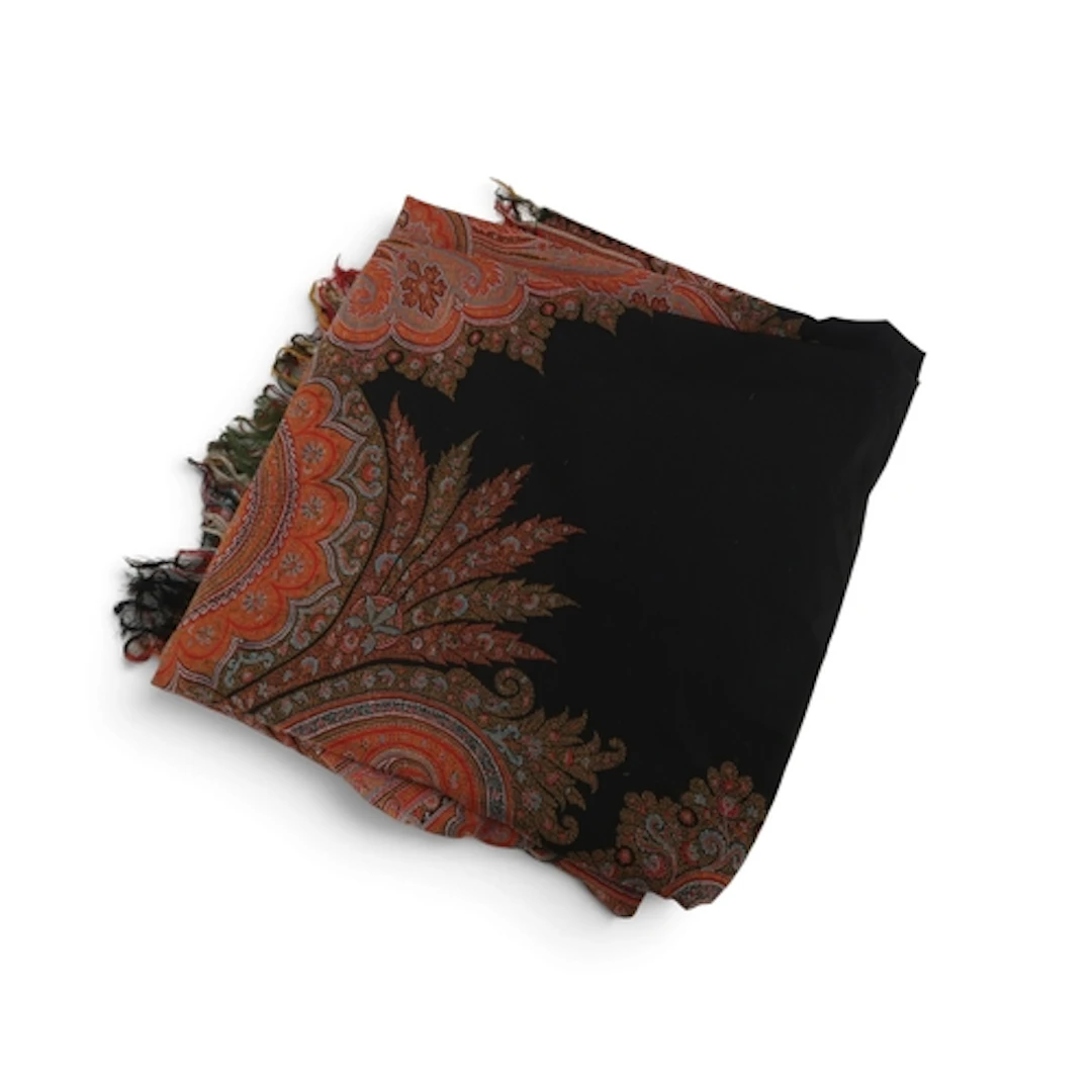 A black ground Paisley shawl woven with elongated boteh, pal...