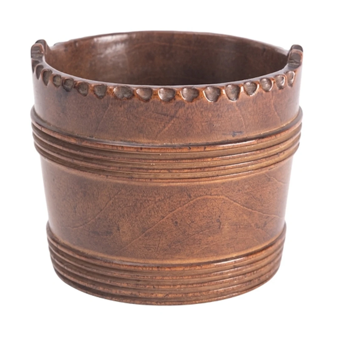 A turned treen vessel modelled in the form of a Dutch bucket...