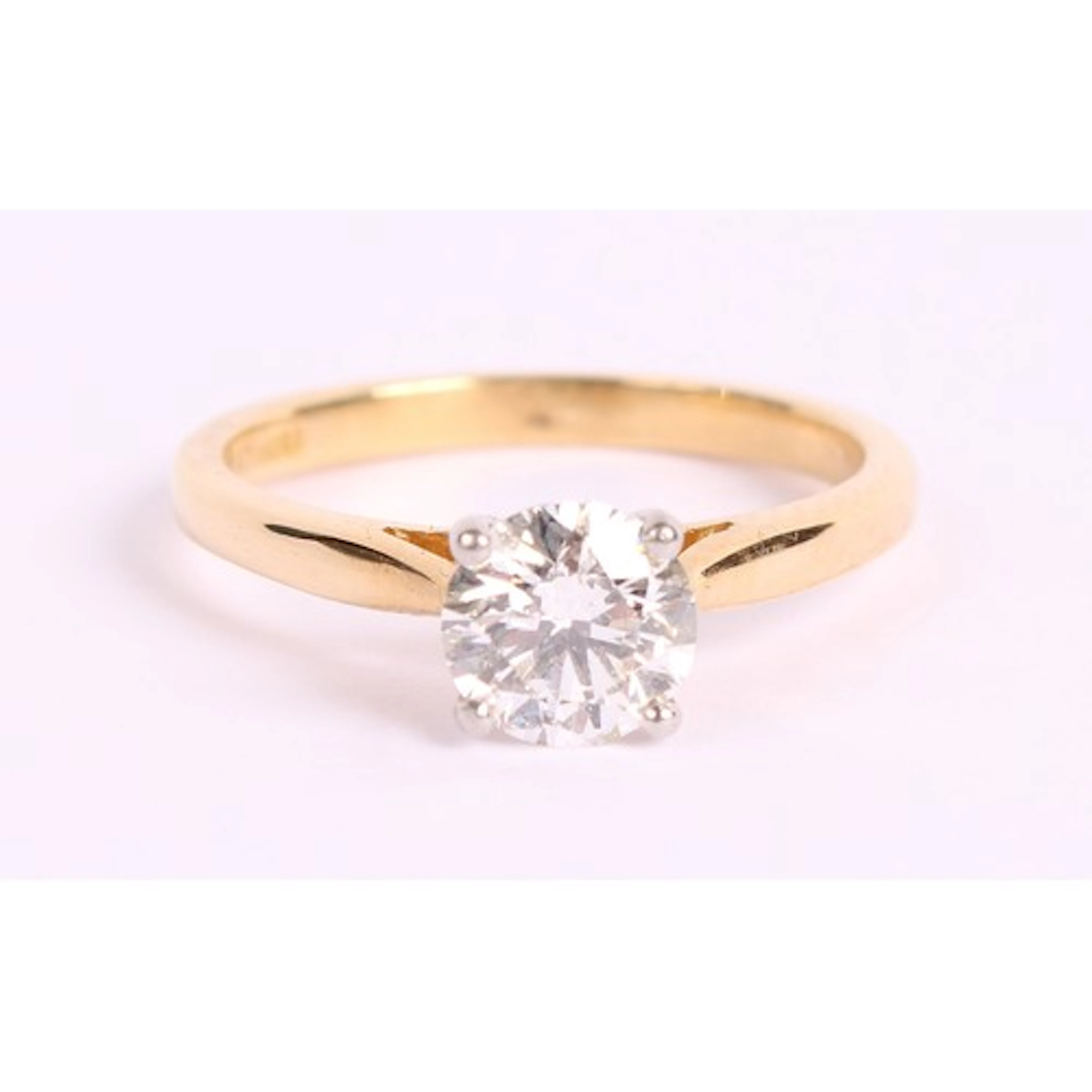 An 18ct gold diamond solitaire ring, platinum bezel, the sto...