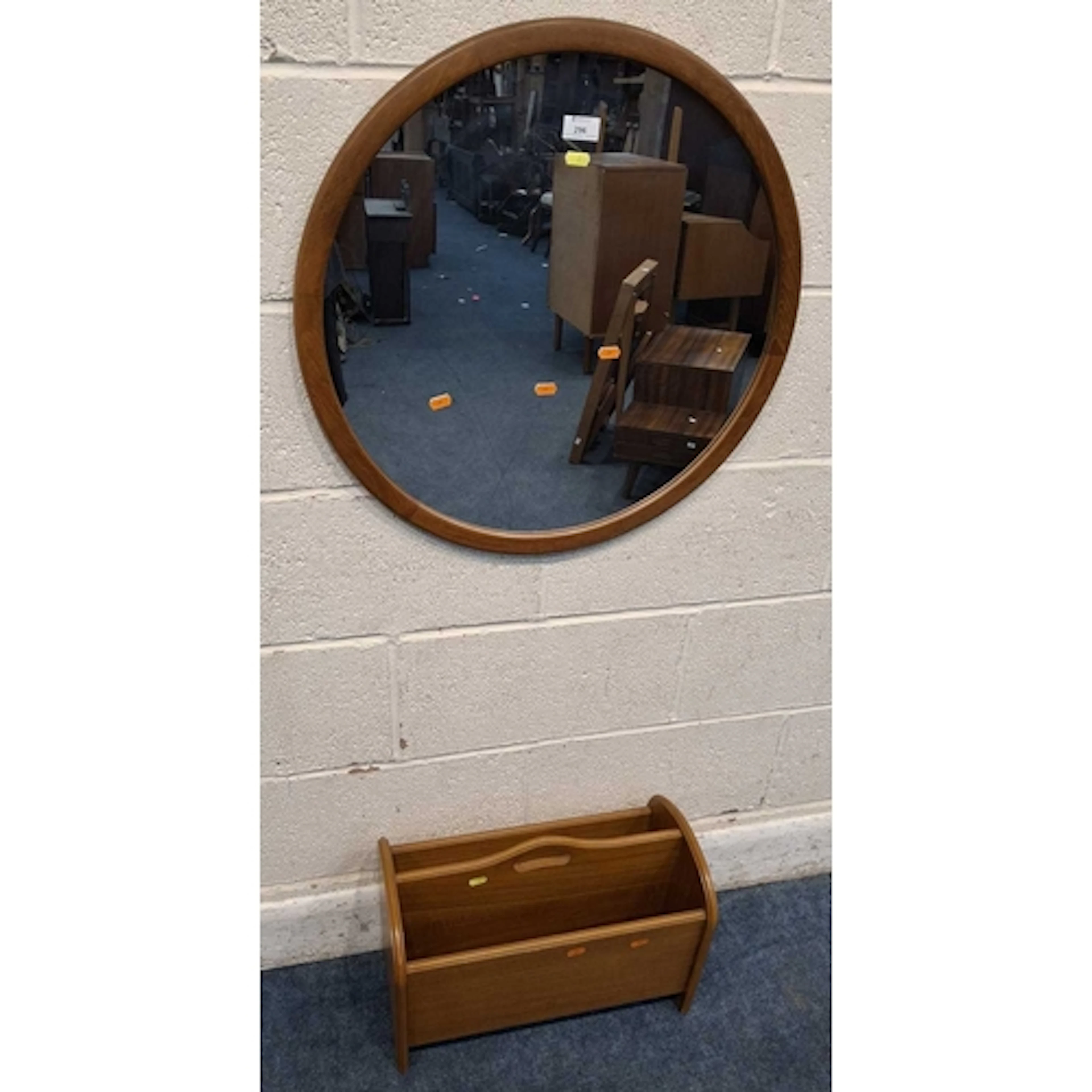 A CIRCULAR WALL MIRROR, along with a magazine rack (mirror ...