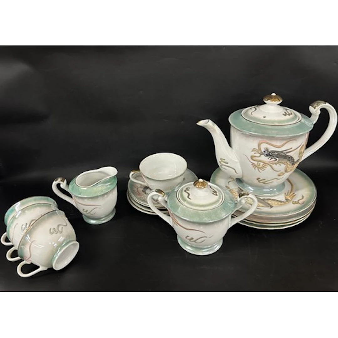 An oriental tea service with dragon detail, four setting, ch...