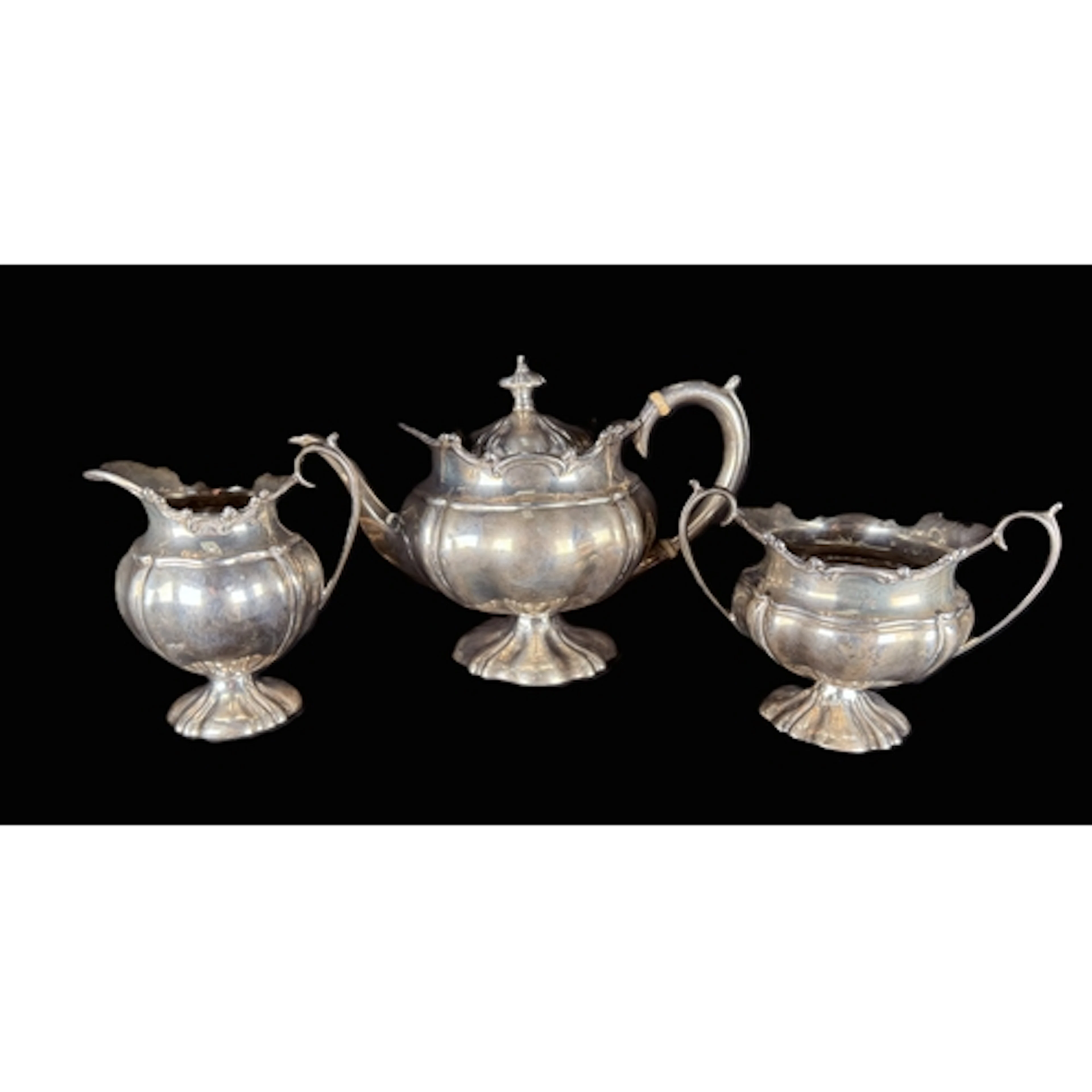 A Rococo style hallmarked silver 3 piece tea set with ribbed...