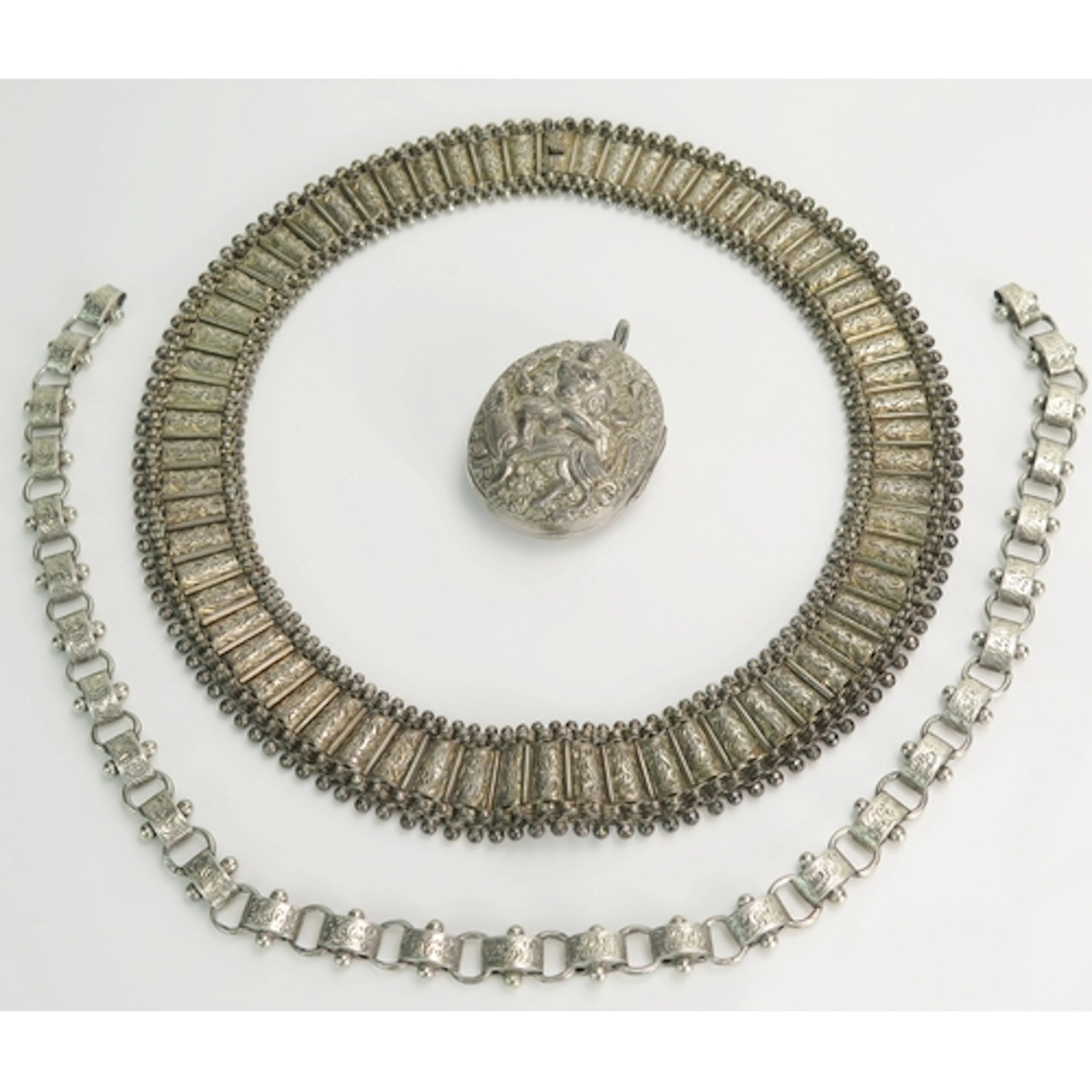 A Victorian precious white metal collar with chased decorati...