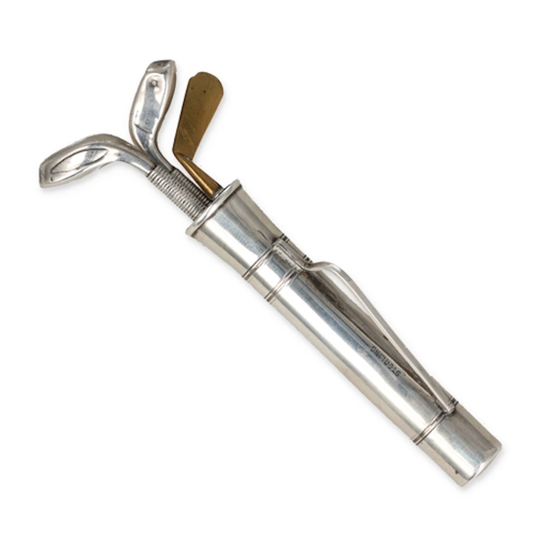 A STERLING SILVER NOVELTY NECESSAIRE IN THE FORM OF A GOLF B...