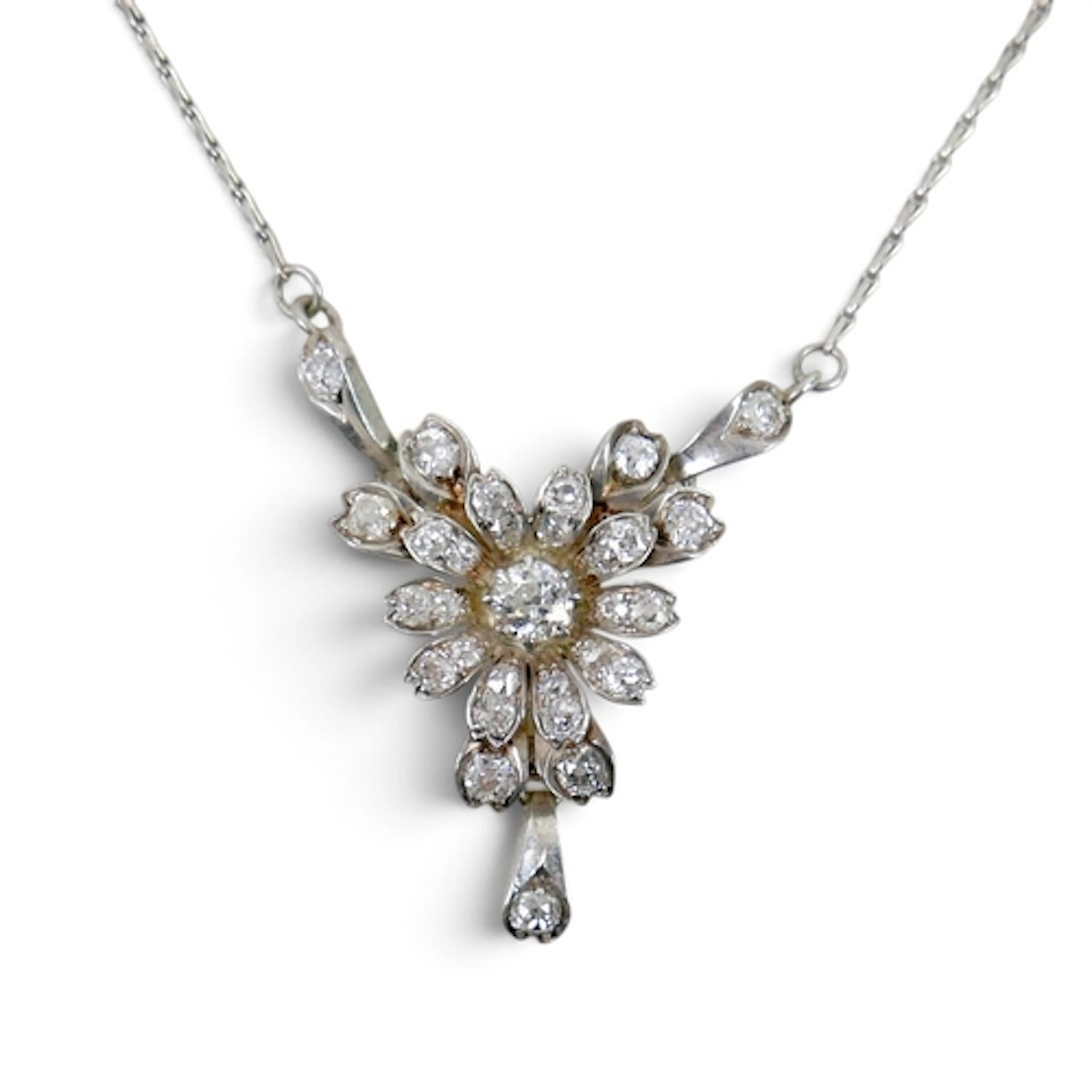 A VINTAGE DIAMOND FLOWERHEAD PENDANT NECKLACE. the central o...