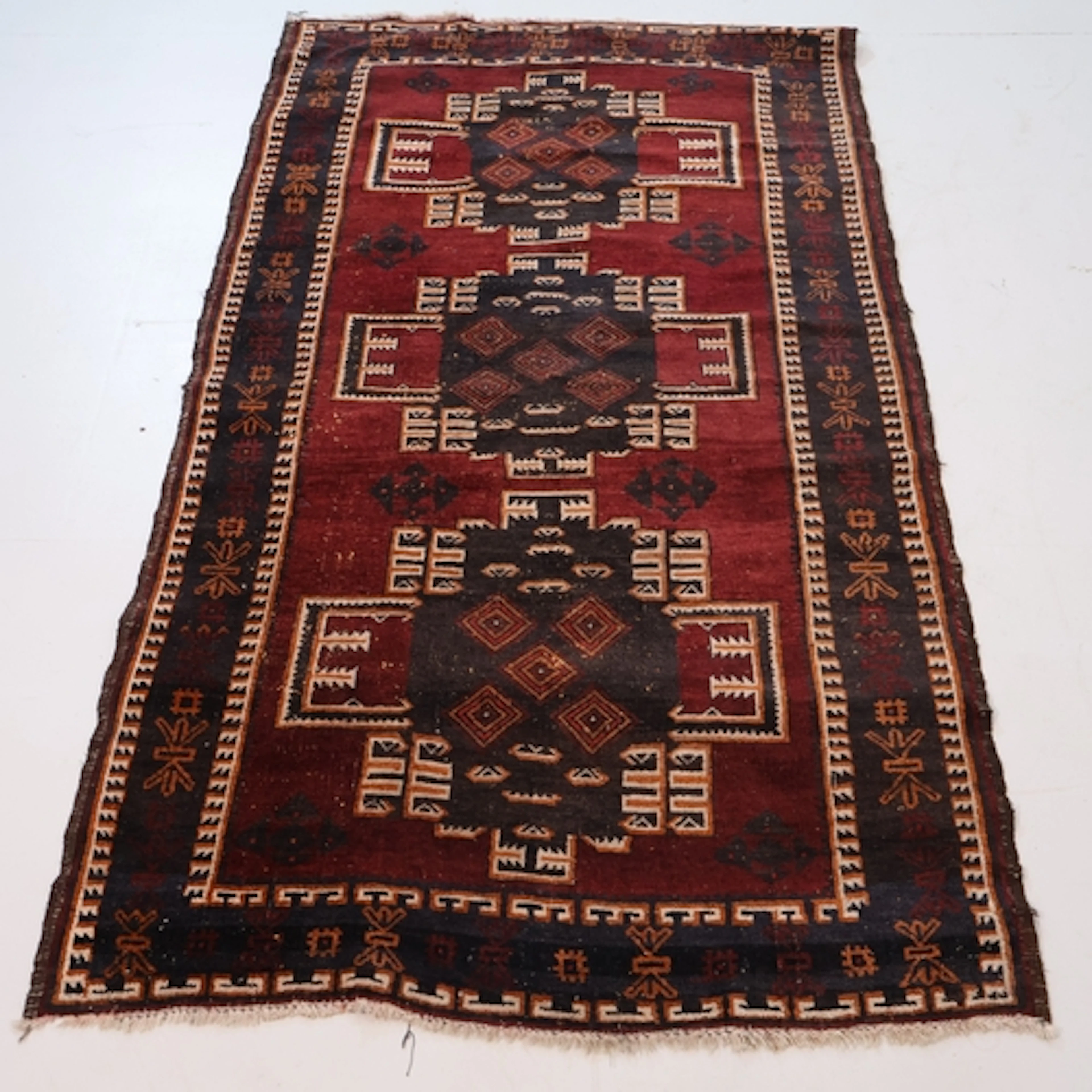 A red ground Baluch rug, L190cm, W109cm.
