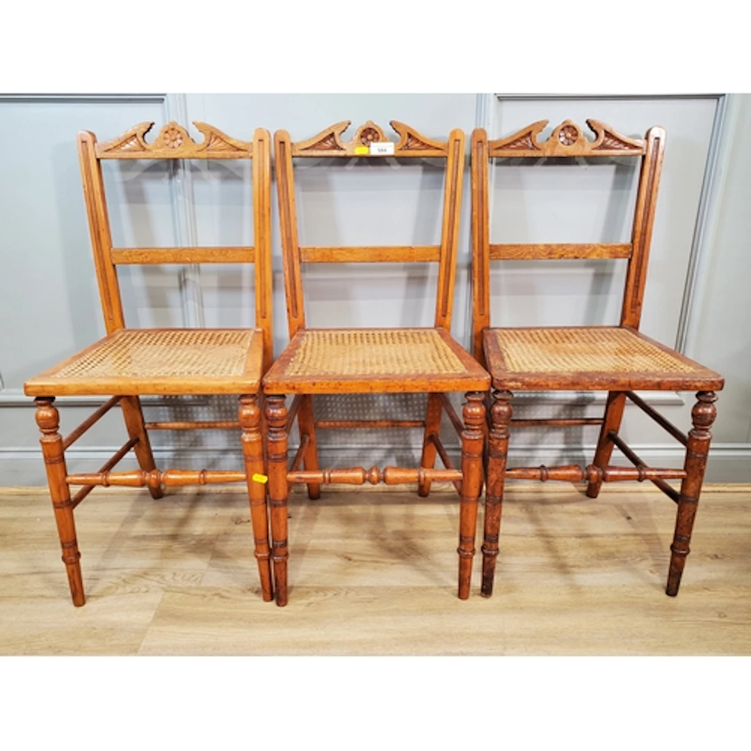 Three carved walnut framed Chairs with cane upholstered seat...