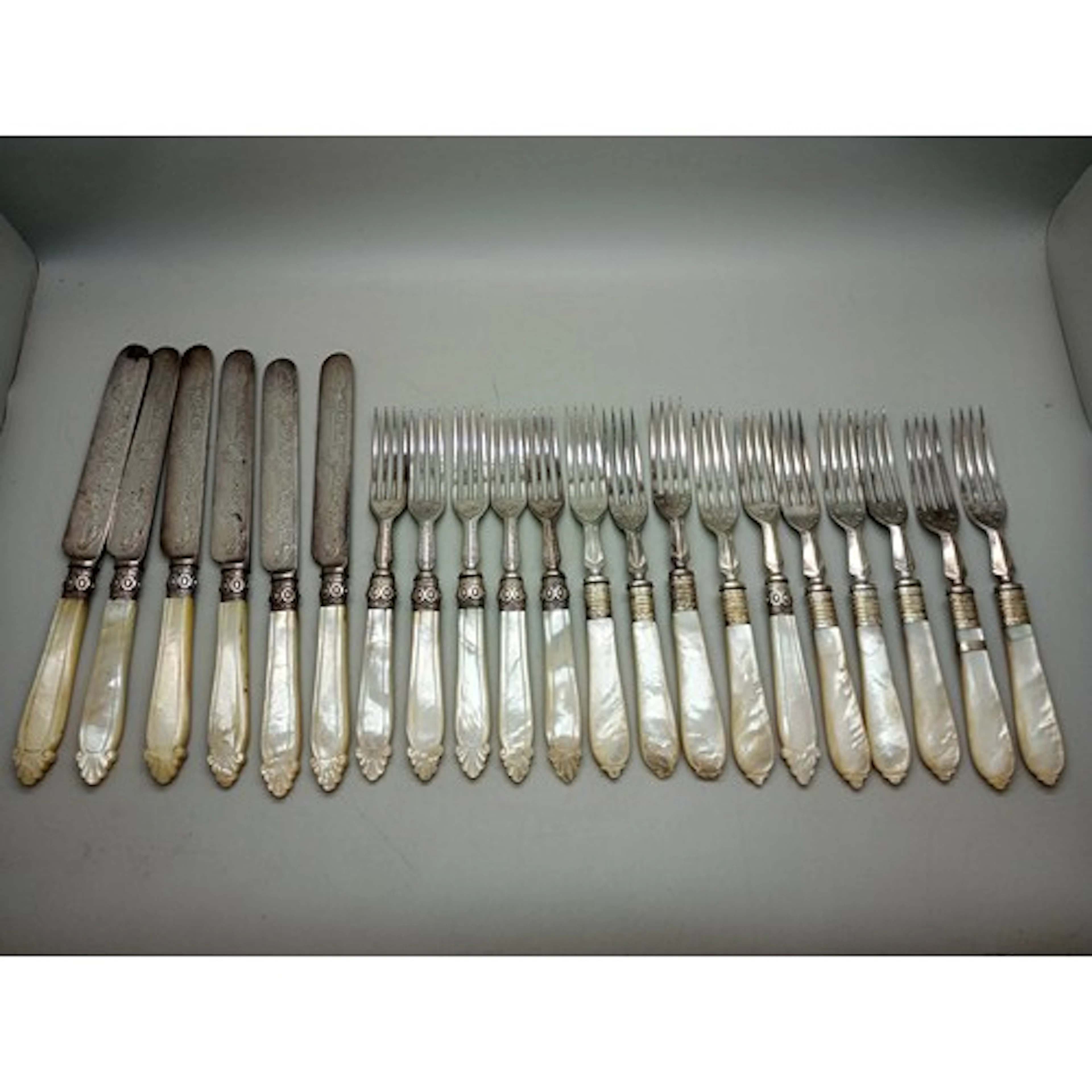 A set of 19th century silver plated cutlery with carved moth...